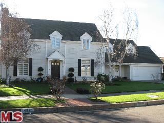 Located on one of the most sought-after streets in prestigious Huntington Palisades, this two-story Traditional Cape Cod boasts four bedrooms and four and one-half baths, including a master suite with sitting area on the upper level opening to a large balcony with ocean view. Light and bright, the interior of this spacious home features hardwood floors, recessed lighting, a formal dining room, living room with fireplace, and a kitchen/family room combo with center island and breakfast bar, eating area, wet bar, and second fireplace. Two sets of French doors open to the huge, beautifully landscaped backyard with wrap-around brick patio and pool, ideal for entertaining and al fresco dining. Other amenities include inside laundry, an upstairs bonus/play room, and a two-car attached garage. While offering the ultimate in privacy, the property is within convenient proximity to schools, shops, restaurants, and a private neighborhood park overlooking the blue Pacific.