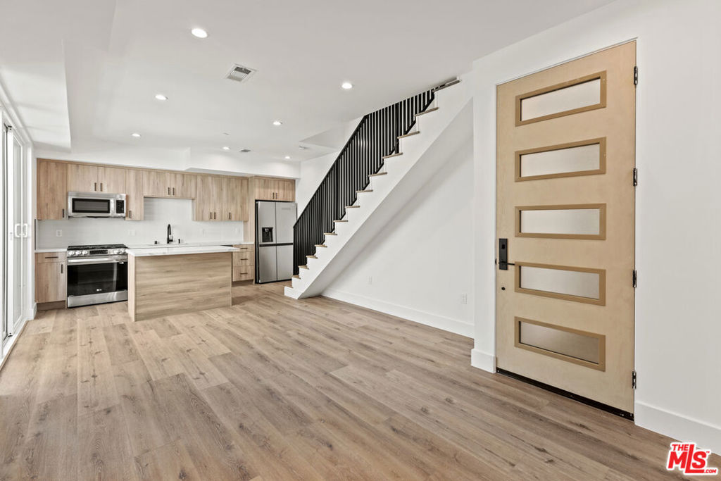 Welcome to this stunning newer-construction luxury townhome, perfectly situated in the vibrant and highly sought-after NOHO Arts District. Combining modern elegance with urban convenience, this meticulously designed residence offers the ideal blend of style, comfort, and location. Boasting 3 spacious bedrooms, 3.5 designer bathrooms, and approximately 1,600 square feet of open-concept living space, this multi-level home features high ceilings, wide-plank wood flooring, and abundant natural light throughout. The gourmet kitchen is a chef's dream, outfitted with high-end stainless steel appliances, quartz countertops, custom cabinetry, and a large center island, perfect for entertaining. Retreat to the luxurious primary suite complete with a walk-in closet, spa-inspired ensuite bath with dual vanities, and oversized glass-enclosed shower. Each bedroom offers privacy and en-suite access, ideal for guests or a home office setup. 1 car garage and 1 carport space parking. Located just moments from trendy cafes, theaters, galleries, and the Metro Red Line, this townhome offers the best of urban living in one of LA's most exciting neighborhoods.