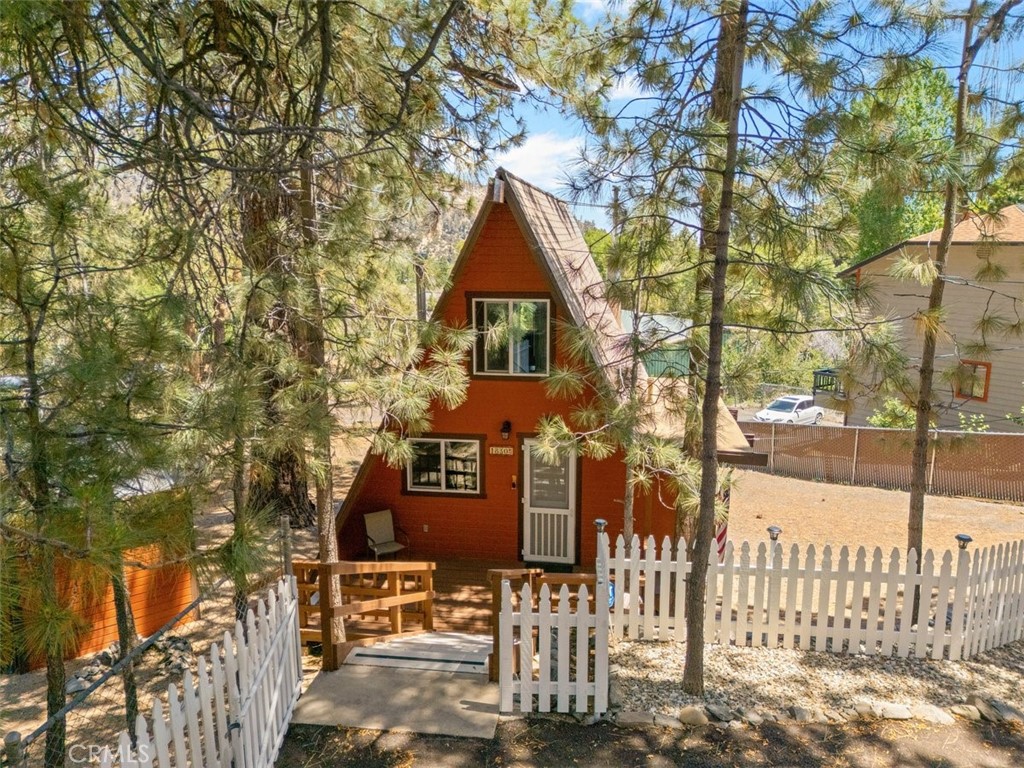 Come enjoy the mountain views this A-frame cabin has to offer. If you've been looking for a cozy mountain cabin, this is it! Views and privacy make this your dream mountain home. Well-maintained and move-in ready make this a must-see home. Entering on the main level you will be greeted with warm wood walls and vaulted ceilings. Completing this space is an efficient kitchen, roomy living area with dining space, cozy pellet stove and bedroom directly across from the full bath. Walk out the living area to a beautiful deck for entertaining while enjoying the fantastic scenery. Upstairs is a loft bedroom providing room for your guests. The lower level has a second living space with wood-burning stove and access to a patio, large rear yard and detached storage shed. Also on this level is another bedroom and bath. The entire lower level could be used as a primary bedroom/bath. Laundry closet is conveniently located in a closet adjacent to this bedroom. This large 9000 sq ft lot is completely fenced and also boasts a paved parking area for up to 4 vehicles. Upgrades include newer dual paned windows, roof and septic system. This delightful home could be yours for the price of $420,000.