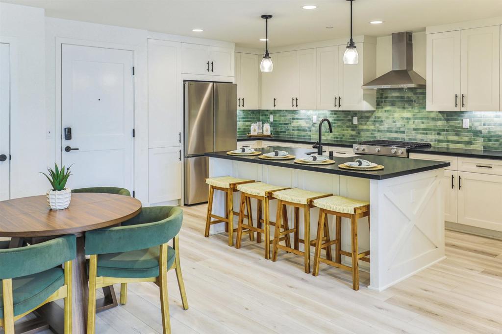 Own a large, remodeled 2 bedroom/2 bathroom condo in Fox Point Farms, coastal living in the heart of Encinitas. Just 1.5 miles from the beach, this is a rare opportunity to live in this new, award-winning, ocean-view community designed with modern finishes and farmhouse-inspired charm. This beautiful remodeled 2-story home offers easy living with 1,180 square feet, vaulted ceilings, loft converted to a second, larger primary bedroom, fully owned solar, and many upgrades and amenities! This home has no neighbors above or below. It features granite countertops in the kitchen and bathrooms, a beautiful kitchen island with seeded glass pendants, custom kitchen backsplash, farmhouse sink, painted maple shaker cabinets, and high-end Kitchen Aid appliances. Luxury vinyl plank flooring throughout is paired with upgraded shower tiling and cabinets in the bathrooms. Smart home compatible, it includes fully owned solar, whole home water filtration and air purification systems, lots of windows, spacious private patio, and a large 1-car garage with built in storage. Fox Point Farms is a thoughtfully designed “agrihood", cultivating community with neighbors and friends through agriculture, local artisans, food, and amenities. Completely sold out and with a waitlist of over 4,000 people, it includes a 3-acre organic farm, Fox Point Brewing Company, Fox Point Roasters, fine dining at HAVEN Farm + Table, Harvest Market and coffee shop, Huerta Taco Stand, community gardens and, coming this fall, a new clubhouse with pool, fitness center, golf simulator, and more. Steps from your front door you can enjoy yoga, breakfast, lunch or dinner, and watch the sun rise or set over the ocean with a fresh cup of coffee or a beer, all created on site, with the Encinitas Ranch Golf Course across the street. Whatever stage of life you are in, this condominium and community is perfect for relaxing, entertaining, working, and living!