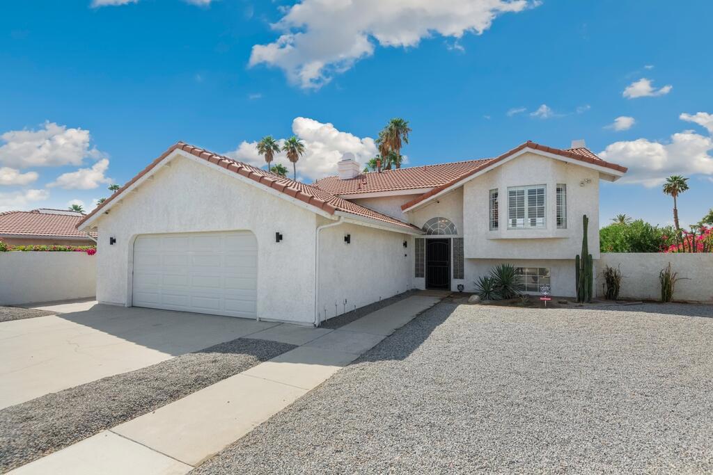 Stunning split level pool home offers great curb appeal with fully gated front yard and driveway, and low maintenance rockscape and cactus landscaping. The interior features vaulted ceilings with recessed lights, plank floors in the main living areas, 2 primary bedrooms, and many upgrades throughout including a new A/C unit in 2024. The formal entry has a gorgeous chandelier, take the staircase up to the main floor with spacious living room with fireplace and updated kitchen offering white cabinetry, stainless steel appliances, tile backsplash, and a center island with bar seating. There is a balcony with views of the backyard and pool. The primary suite is also located on the 2nd floor and also offers a private balcony, a 2-way fireplace and a spa-like ensuite with fireplace, 2 pedestal sinks, a soaking tub, and a walk-in closet with built-in storage. Downstairs you will find a bonus room with a kitchenette - great for guests or hosting parties, there is a fireplace, a private covered patio, a full-size bathroom, the laundry room, plus 2 more bedrooms with 1 bedroom including a private ensuite. The gorgeous backyard is like your own private resort with in-ground pool and spa, turf grass, covered pergola, palm trees, lush privacy hedge, and new landscape lighting installed in 2024! There is also an attached, insulated, 2-car garage with A/C! Located on a large corner lot, and no HOA fees, schedule your private tour today!
