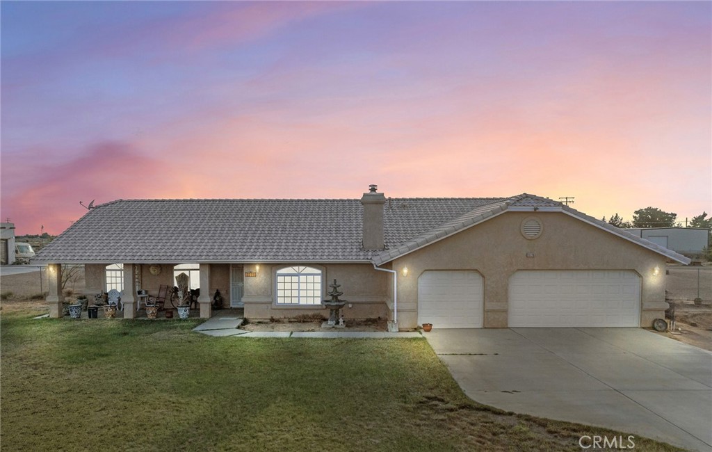 Tucked away in the quiet outskirts of Apple Valley, this 2,000 sq ft desert gem sits on 2.3 acres of wide-open space—just off the pavement, with room to roam and views that’ll stop you in your tracks.
Step inside and you'll find a well-laid-out 4-bedroom, 2.5-bath home with a smart split floor plan—master suite on one side, the other three bedrooms on the other. Vaulted ceilings give the whole place an open, airy vibe. The indoor laundry room is tucked just off the attached 3-car garage (yep, with its own half bath—super convenient!).
This front porch is made for rocking chairs, slow mornings & a nice cup of coffee, while the shaded back patio is perfect for BBQs and watching the sun dip behind the mountains.
Got animals? Bring 'em all! There's space for livestock, plus electric already run to the hay shed and storage container. Hosting guests with RVs? We’ve got hookups ready to go.
Now let’s talk about the showstopper: a 1,950 sq ft oversized garage out back with its own 1/2 bathroom (not included above) on a completely separate septic, and brand new solar. Whether you’ve got toys, tools, or big ol' dreams— This home is ready for it all.
Big skies, mountain views, and the kind of peace that only the desert can offer. This one’s got soul—Come see it for yourself!