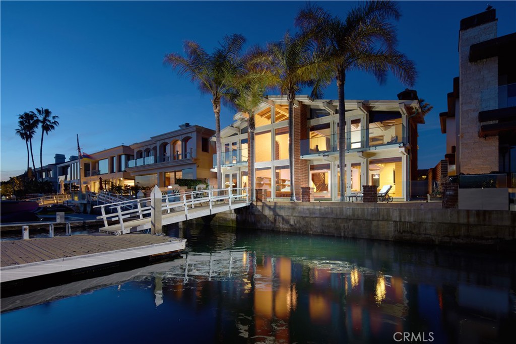 Unparalleled Bayfront Living on Linda Isle. This fully furnished residence on the exclusive “Gold Coast” of Linda Isle is arguably the finest
view lease to hit the Newport Beach market in a decade. Positioned just seven homes from the
island’s southwest tip, the home commands spectacular panoramic views of Newport Harbor’s
main turning basin—widely considered the most iconic and dynamic water view in the city.
Enjoy front-row seats to daily sailing regattas, morning crew workouts, yacht traffic, and
breathtaking year-round sunsets. The home’s premier southwestern exposure also offers
unmatched vistas of the world-famous Christmas Boat Parade. Designed in a timeless mid-century style, the residence offers nearly 5,000 square feet of light-filled living space with 4 spacious bedrooms, 4.5 bathrooms, a formal dining room, den/office,
and a grand bayside living room that opens to a generous patio overlooking the water. An
interior courtyard with a tranquil fountain and private spa adds a serene escape within the home.
With 60 feet of waterfront, the private dock accommodates a vessel up to 60 feet plus a side-
tie—perfect for boating enthusiasts. As an added bonus, the lease includes use of a well-
appointed 22-foot Duffy electric boat for cruising the harbor, available to tenant for an additional
fee. Linda Isle is Newport Harbor’s only exclusive 24-hour guard-gated island of 107 bayfront
homes. Community amenities include a private tennis court, clubhouse with sandy beach and
play area, and secure entry. This is a rare opportunity to lease one of the harbor’s most
prestigious and view-centric properties