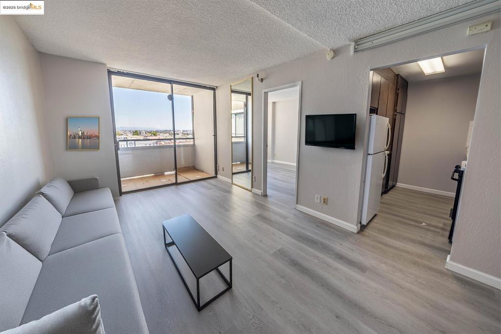 Welcome to 801 Franklin Street – a stylish 1-bedroom condo located in vibrant Downtown Oakland. Enjoy new luxury vinyl wood flooring, fresh paint, and an open, airy layout filled with natural light. The spacious bedroom features large windows, and the private balcony offers stunning city night views. Secure enclosed parking, low HOA fees, and unbeatable access to trendy shops, acclaimed dining, public transit, and major freeways make this home ideal for urban living. Just steps from Lincoln Elementary and surrounded by the energy of Chinatown, this is your chance to own a piece of Oakland’s cultural core. Don't miss out on this modern city retreat. A perfect blend of city energy and modern comfort.