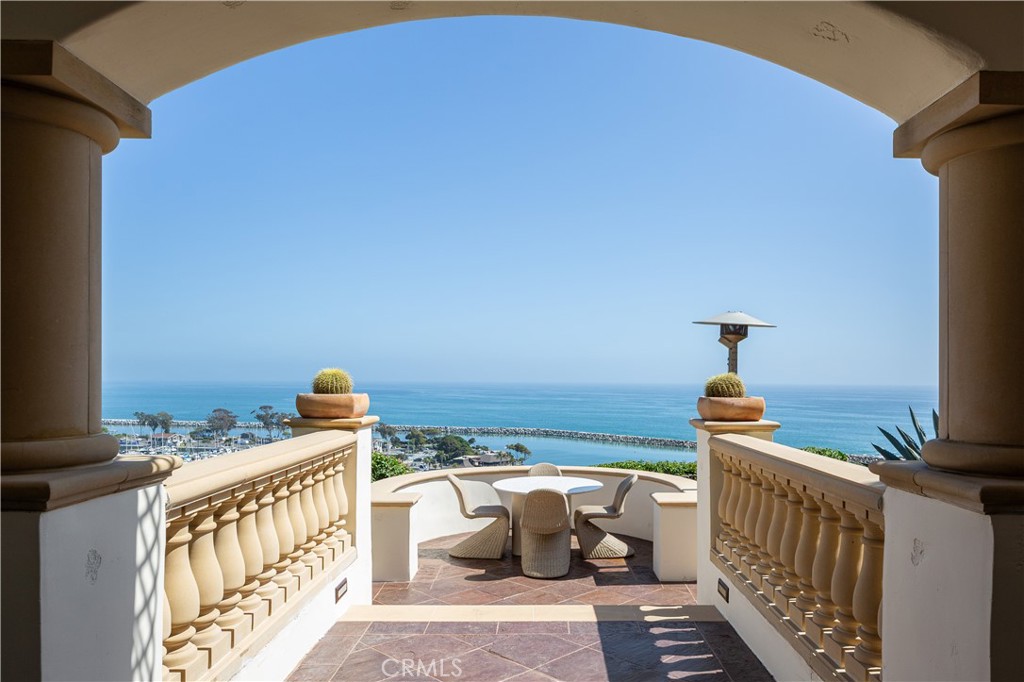 Welcome to Casa Santa Clara, an exquisite Spanish Colonial Revival estate perched atop the bluff overlooking Dana Point Harbor. Inspired by the iconic works of Wallace Neff, this custom home embodies the timeless elegance of early California architecture, seamlessly blending Old World craftsmanship with modern luxury.
From the moment you step inside, sweeping panoramic ocean and harbor views captivate the senses, while the meticulous design details-hand-painted tiles, intricate wrought-iron accents, and exposed wood beams--reflect the unmistakable influence of Neff's refined aesthetic. The main house offers three beautifully appointed bedrooms, while the guest house features two additional bedrooms, creating a private retreat for visitors. These two parts of the property are connected by a stunning courtyard, where a vibrant Marlo Bartels fountain serves as the crown jewel, celebrating the rich tradition of Spanish tile artistry. Throughout the home, these intricate tiles emerge unexpectedly, adding warmth and character to the crisp, eggshell stucco exterior (originally textured by Sicilian craftsmen) all homages to Neff's architectural legacy. Designed for effortless coastal living, Casa Santa Clara spans three levels, all accessible by a private elevator. The gourmet kitchen, adorned with custom cabinetry and premium appliances, opens to an inviting dining and living area, perfect for entertaining. The primary suite is a sanctuary of its own, offering a spa-like master bathroom and a private balcony to take in the breathtaking ocean vistas. On the third level, a game room/study provides an intimate retreat with unmatched views. The guest house features a mirrored room to host a gym and a home theater in the living quarters equipped with an audio surround system. Step outside onto the expansive terraces and lushly landscaped patios, where ocean breezes and golden sunsets set the stage for al fresco dining and relaxation. With an unrivaled location just moments from Dana Point's world-class marina, pristine beaches, and the charming Lantern District, this estate offers a rare opportunity to own a piece of California's most coveted coastline. As the Dana Point Harbor Revitalization project unfolds, the future shines even brighter. Experience the pinnacle of luxury living in this Wallace Neff-inspired masterpiece schedule your private tour today.