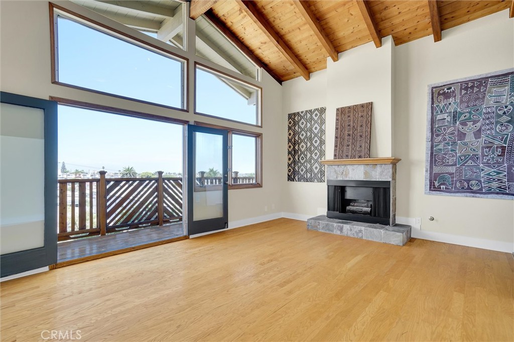 Prepare to be amazed by this unique home with panoramic city and mountain view. Located on what is arguably the best, wide and lightly traveled one way street in Golden Hills, with parking on both sides of the street. This custom designed single family residence features a dramatic floorplan that you will not find anywhere else in this prime Golden Triangle neighborhood, literally across the street from Hermosa Beach, and a few blocks south of Manhattan Beach. Warm and unique throughout, this home has been dubbed "Norwegian Wood" by the same owner for 25 years. The panoramic view spans from the Hollywood sign to the north, and harbor to the south. Soaring wood beamed ceilings throughout the entire upper level. The living room, with floor to ceiling doors and windows, leads to a balcony which further enhances the view. The fireplace completes the experience of this unique gathering area. The top level primary bedroom with high vaulted wood ceiling, also takes advantage of the picturesque mountain view to the east. Cedar lined walk-in closet with built-ins, and full bath with jacuzzi tub, add to the experience. Refrigerator, washer and dryer, are included. Kitchen features granite countertops, custom oak cabinetry, and all appliances. The adjacent family room offers yet another balcony from which you can wave to your neighbors as they stroll by in this friendly, very walkable and quiet neighborhood. Double garage with built-in cabinetry, utility sink, and liquid granite flooring. And don't miss the separate large, lower bonus storage/workshop room, with dedicated exterior side entry, not included in the square footage. Interior just professionally painted, new baseboards, new carpet. Hardwood and full interior professionally cleaned throughout. Unique, custom designed redwood deck rails and fencing. Drought resistant landscaping with timed dripless irrigation system. Parking for 7 cars!! (Two in garage, 4 on driveway, and 1 that can legally park on street in front of driveway) Feels much larger than the square footage would lead you to believe. Just add furniture!
