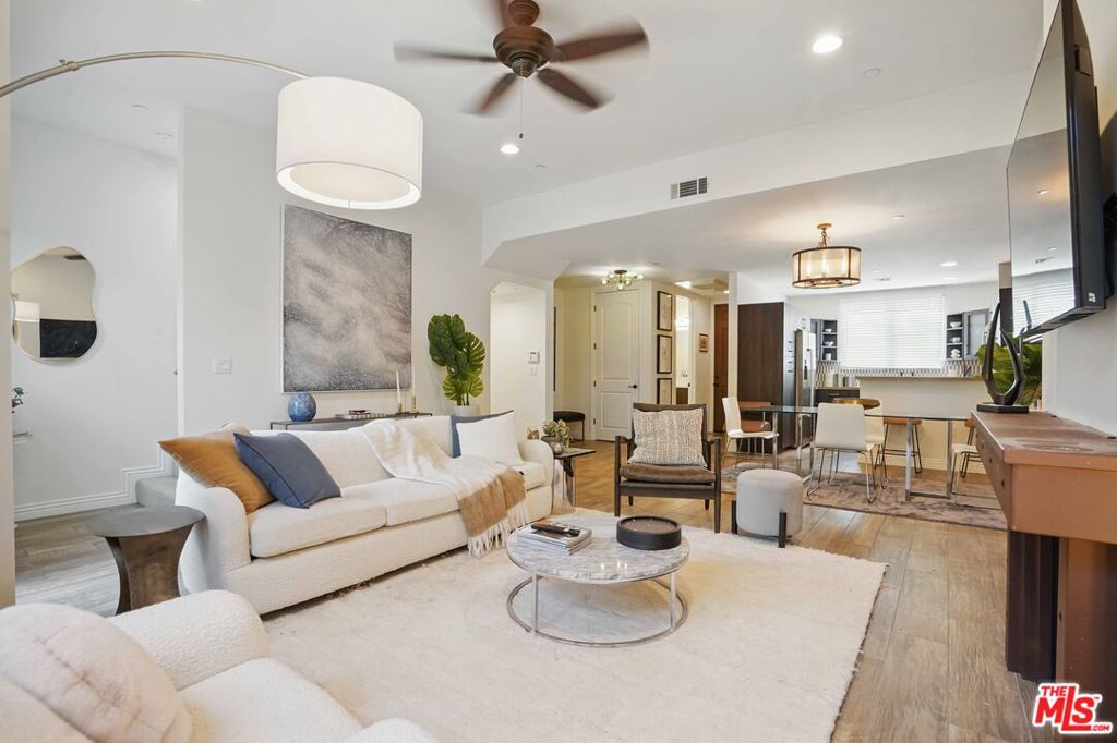 Welcome to the Colfax Villas! A magnificent, 12-unit Santa Barbara Spanish inspired architectural residence unlike any other in the area! Constructed in 2012 utilizing innovative design and meticulous attention to artful detail with Spanish tiles, fountain, archways, and serene courtyard. Inside, a lifestyle of luxury awaits with this stunning, executive townhome. The open, flexible floor plan is optimally designed for easy, relaxed contemporary living and entertaining with interiors the epitome of sleek and chic. Finishes are warm and inviting with wood floors gracing the living areas. Exquisite lighting throughout casts an ambient glow. Modernized baths are dressed in fine fixtures and finishes. The kitchen is an open culinary center designed for the adventurous at home chef. Artfully adorned with an array of fine stainless steel appliances, abundant cabinetry and gleaming countertops. The dining area lends itself ideally for friend and family gatherings of all occasions. Sliding glass doors open from the great room to a private balcony bringing the outdoors in. Three bedrooms with three bathrooms including a lux primary suite with vaulted ceilings, private terrace with lush, nature views and walk-in closet round out the comfortable accommodations for family and guests. Highlights include secured access, lower level multipurpose bonus room/flex space, in-unit laundry, guest parking, earthquake insurance and PRIVATE, DIRECT ACCESS 2-CAR GARAGE! Located in one of the Valley's premier destinations, in the acclaimed Colfax Charter School District, and just moments from Woodbridge Park, the Tujunga Village, major film and TV studios, the chic dining and shopping district along famed Ventura Blvd. and all the best of what fabulous Studio City has to offer. This is the place where you want to live. Welcome!