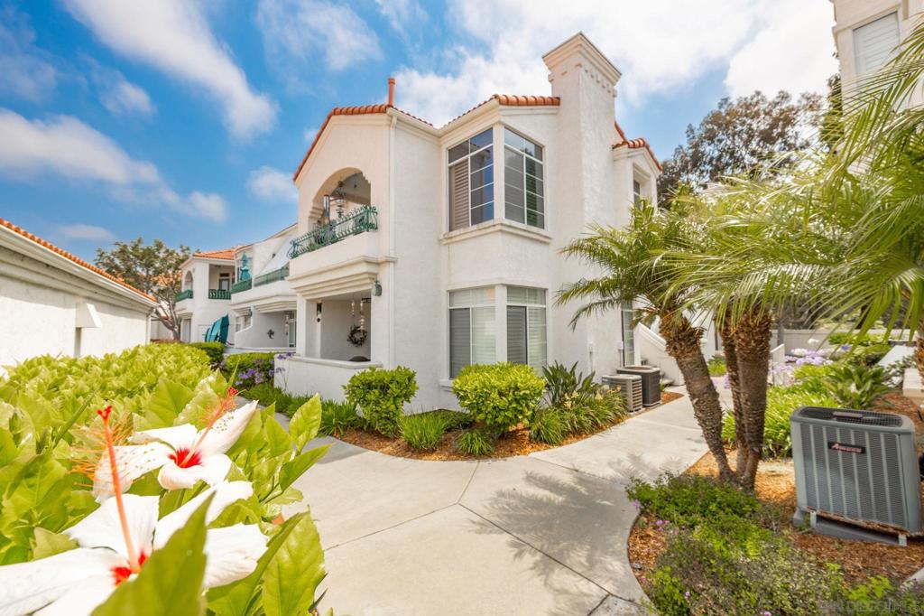 Welcome to resort-style living at the highly desirable Villa Trieste 55+ gated community! This beautifully maintained 2-bedroom, 2-bath single-level condo offers an open floor plan filled with natural light, updated finishes, fireplace, dining area and TWO separate private patios perfect for relaxing or entertaining. Enjoy a spacious upgraded kitchen with quartz counters, stainless steel appliances, ample cabinetry, and a cozy breakfast nook. The primary suite features a walk-in closet and a large en-suite bath with shower. Mahogany hardwood floors throughout. This ground-level unit includes a detached one-car garage, full in-unit laundry closet, NEWER central air conditioning and freshly painted interior! Villa Trieste offers wonderful amenities including highly maintained grounds, community heated pool, spa, clubhouse, and walking paths, a gazebo, bocce ball court, picnic and park areas. Located minutes from shopping, dining, golf, and parks. Building roof was replaced by community in 2024!