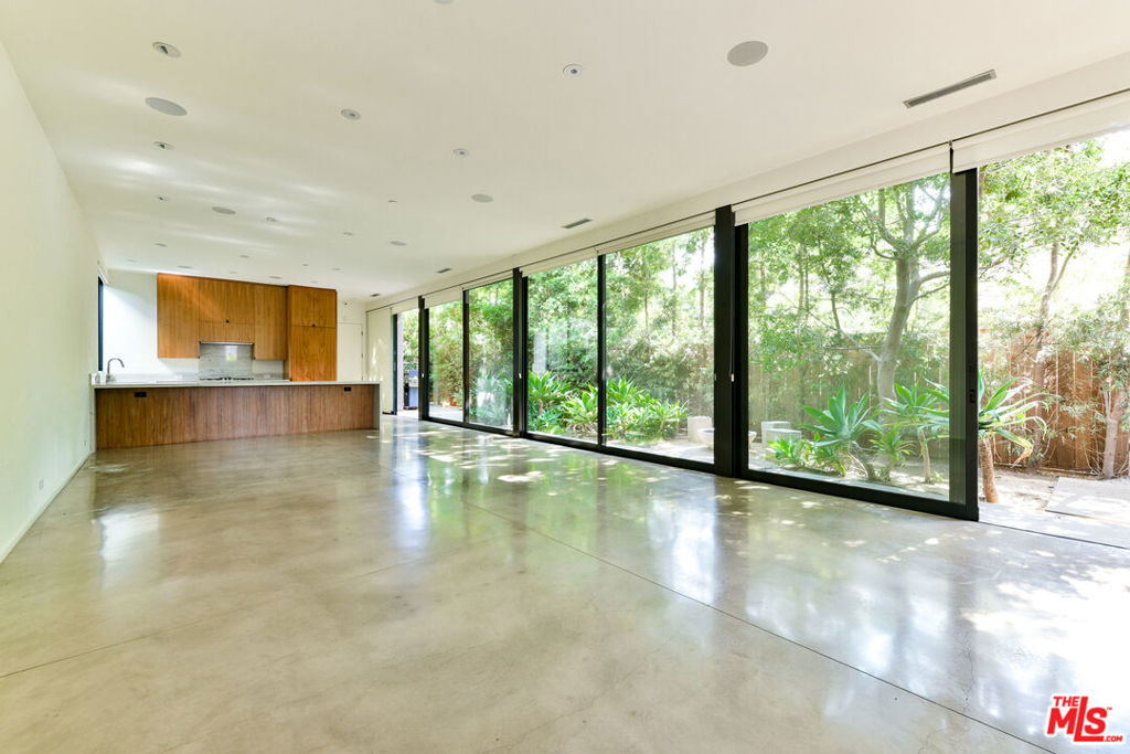 Stunning Marmol Radziner-Designed Modern on highly coveted Milwood Ave! Experience refined Venice living in this architecturally striking home. Bathed in natural light, the main level boasts soaring 10-foot ceilings and seamless indoor-outdoor living, courtesy of expansive sliding glass doors that open to a lush, private yard complete with a built-in BBQ and fire pit an entertainer's dream.Crafted with the finest materials, this dramatic and spacious residence offers elevated design and functionality throughout. The state-of-the-art chef's kitchen features top-of-the-line Miele & subzero appliances, an oversized walk-in pantry with a wine fridge, abundant walnut cabinetry, and a large breakfast bar ideal for casual dining or hosting guests.Upstairs, a versatile flex space serves as a perfect office or play area. The breathtaking primary suite includes dual walk-in closets and a spa-inspired bath. Two additional generously sized bedrooms each feature en-suite baths, and a convenient walk-in laundry room adds to the thoughtful layout.Additional highlights include a cutting-edge security system, a two-car garage with an EV charging station, and two additional parking spots, offering rare off-street parking for four vehicles in total. This exquisite home blends luxury, design, and location offering a rare opportunity to enjoy Venice living at its very best.