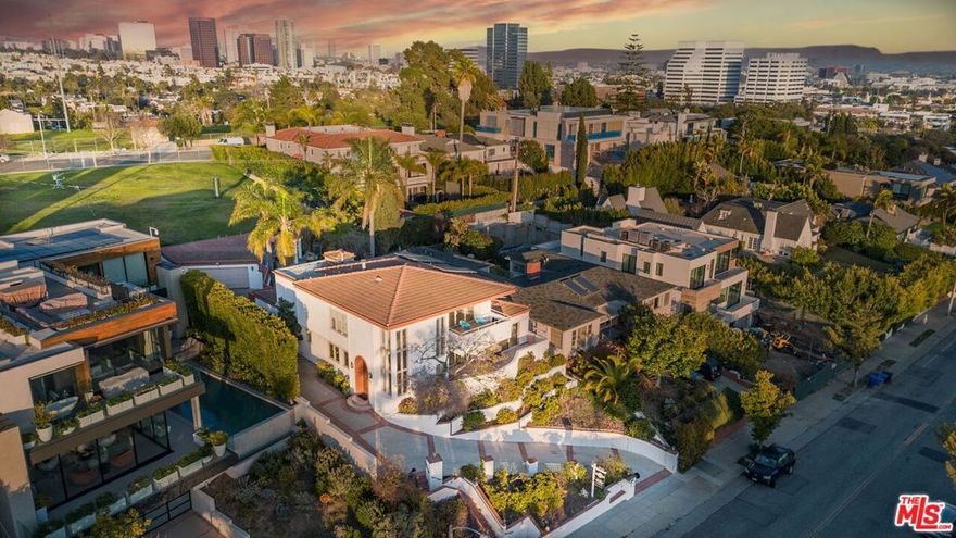 Perched atop Berkeley Street in Santa Monica, this exceptional 4-bedroom, 4.5-bathroom home offers panoramic views of the ocean, mountains, and city skyline. Designed to capture its stunning surroundings, the home features expansive windows and seamless indoor-outdoor flow, filling every space with natural light and breathtaking vistas.  The open living areas lead to a tastefully designed kitchen that balances style and functionality. Outside, the private pool, spa and yard provide a perfect setting for relaxation and entertaining while enjoying sweeping views.  The luxurious primary suite boasts a spa-like bathroom with a freestanding tub, rain shower, dual walk-in closets, and a cosmetic vanity table. A private balcony offers stunning views of Santa Monica, ideal for morning coffee or sunsets. Each of the four bedrooms includes an en-suite bathroom, ensuring privacy and comfort. A flexible fifth room on the main level is perfect for an office, den, gym or guest room. Additional features include an elevator, dumbwaiter, and a spacious two-car garage with ample storage. Conveniently located near the Brentwood Country Mart, Brentwood Country Club, and Montana Avenue, this home is also just minutes from the Santa Monica Pier and beaches. With its prime location, top-rated schools, and breathtaking views, it offers the perfect blend of luxury and convenience.
