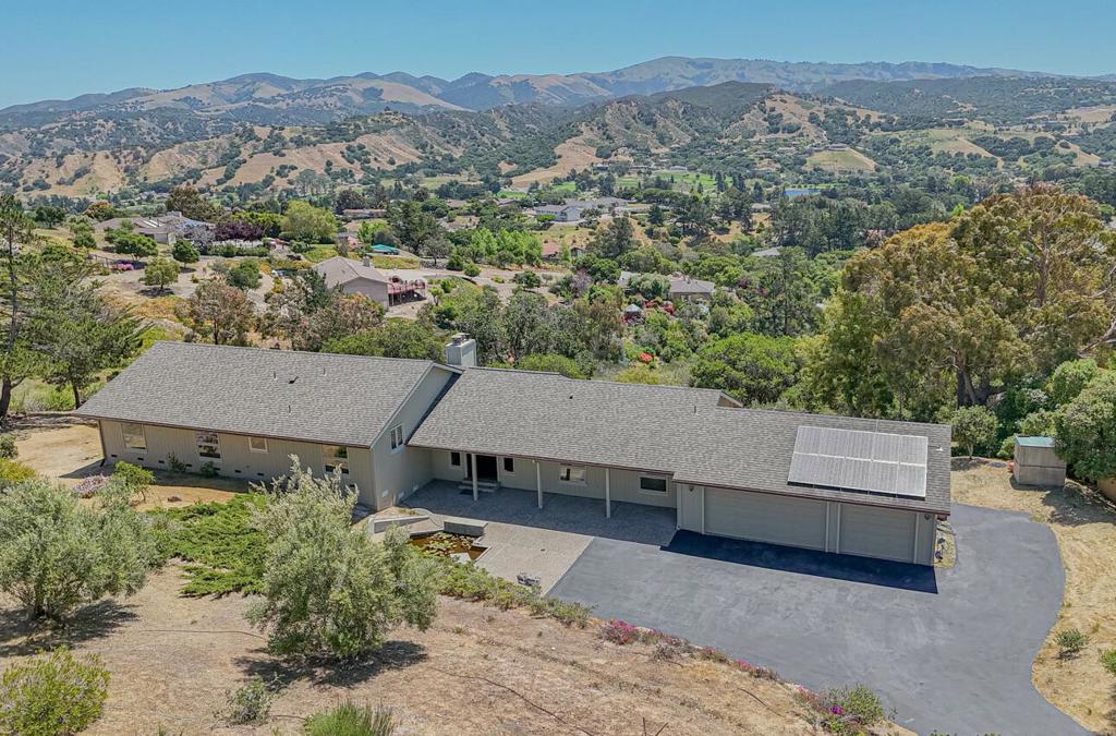 Incredible one of kind views on this mostly single-story beauty on a usable over 2 acre lot! John Steinbeck must have been sitting in this house when he wrote his famous book, Pastures of Heaven! This home is perfectly placed with a premium on privacy and preferred southern sun exposure giving amazing natural light. Oak flooring is leading you to large rooms with lots of windows to enjoy sunrises and sunsets. There is a large primary suite with a wood ceiling, fireplace, walk in closet and sliding glass door out to a beautiful deck and hot tub area stretching almost the width of the house. The primary bath has been completely upgraded. Just down the hall is an amazing en suite perfect for guests, and with upgraded bath as well. Functional kitchen with a window to the world and a breakfast area. The large formal dining room with a large picture window is surely a place to gather and discuss the day or the beautiful surroundings. Just a few steps up, you will find 3 large rooms with a full bath, with room for everyone and privacy. This home draws you out to the vast outdoor space surrounded by mature Oaks and Eucalyptus trees, and with the wonderful colors of nature. Plenty of private parking for everyone with room for an RV. To top it off, this one has owned solar!