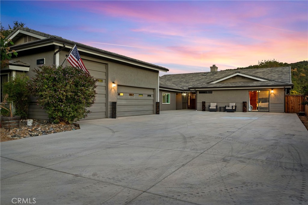 Introducing “Golden Oak Estates” – Completely reimagined with extensive renovations, this 0.34-acre property in the highly desirable gated community of Heritage Ranch offers a perfect balance of elegance, functionality, and resort-style living. Offering oversized garage parking, two primary suites, a private gym, and an expansive backyard with mountain views and protected green space as your backdrop, this home home was designed with comfort and sophistication in mind.
Inside, you’ll find an open and inviting living room with soaring beamed ceilings, a grand stone fireplace, a large ceiling fan, and a wet bar, creating the perfect space for entertaining. A second large family room with double doors offers versatility as a playroom, media lounge, hobby room, or rec room.
The kitchen is a true centerpiece, opening to the dining area and enhanced with a built-in buffet for effortless entertaining. With a breakfast bar, center island with built-in range, stainless steel appliances, wood cabinetry, double ovens, a trash compactor, walk-in pantry, this kitchen is design for both everyday use and grand gatherings.
This home boasts two spacious primary suites, each with dual vanities, walk-in showers, walk-in closets, and sliding doors opening to the front or back yard. One suite also offers a private lounge/office area. A third guest bedroom with its own full bath and a separate laundry room with storage and utility sink provide added convenience.
The property’s appeal extends even further with an oversized three-car garage and a separate additional unit (575 sq. ft., not included in listed square footage) featuring a dedicated gym, an additional half bath, and private office—perfect for wellness, productivity, or guest use.
Outdoors, enjoy a large covered patio for dining, a covered hot tub, and a spacious yard designed to relax and soak in the views of both mountains and open space.
Benefit from minimal electric costs with fully owned solar panels, installed in 2024 along with the new roof.
Golden Oak Estates is more than a home—it’s a private retreat, thoughtfully crafted for everyday living and unforgettable entertaining.