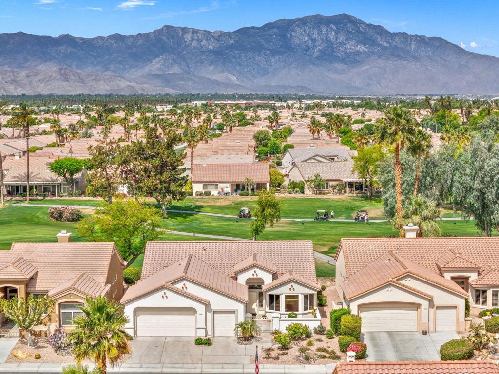 Located in the best 55+ community in the valley, Sun City Palm Desert, this St. Croix model is the most popular. It has 2 bedrooms, 2 baths, and a den, and an extra flex room with a Murphy bed. It has new carpet and new paint inside and out. The open floor plan allows fabulous golf course and mountain views from almost every room. The kitchen has a bay window, with a kitchenette, an island, and a peninsula bar. It has a view of the dining room, living room, and the golf course. The large master bedroom has an amazing view and a bathroom with a dual vanity, walk-in closet, walk-in shower, and a separate toilet room. The guest bedroom is adjacent to the 2nd full bathroom, and is very inviting. The home also has a den and ''hobby room'' for an office, or extra guest room. The laundry includes the washer and dryer, and it leads to the 2-car garage, and a separate golf cart garage. The courtyard and backyard have beautiful, easily maintained landscaping. The 180-degree view of the lush par 3, 3rd hole, of the Santa Rosa golf course and the gorgeous mountain range in the distance. SUN CITY PALM DESERT IS ALL ABOUT LIFESTYLE!! It has many clubs, activities, amenities, and low HOA dues. Play at 2 championship 18-hole golf courses and practice facilities, pickle ball, tennis, softball, bocci ball, an 18-hole miniature golf course, an honor library, arts and crafts, a ballroom for special entertainment, and 4 saltwater pools kept at 87 degrees with hot tubs. Enjoy 2 great restaurants, a martini/coffee bar, and even a post office. There is a newly renovated classy indoor/outdoor bar with fire tables to enjoy the awesome views and our beautiful desert weather. Don't miss this one.