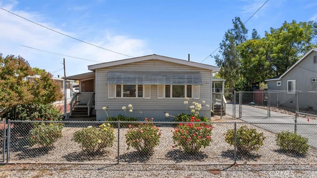 This charming home offers the perfect blend of comfort, functionality, and space in a fantastic location close to parks, schools, restaurants, and shopping. Set on a large, fully gated lot, it features low-maintenance landscaping, a 3-car garage, and plenty of room for parking—including space for your RV. There’s even extra room to create garden beds or enjoy outdoor projects. A covered deck on one side and an enclosed sunroom on the other provide inviting spots to relax and take in your surroundings. Inside, the floor plan is both spacious and versatile, offering a living room, family room, and dining area with a built-in hutch. The kitchen is spacious with crisp white cabinets and lots of cabinet space. You’ll also appreciate the indoor laundry area and additional storage throughout. The home includes two comfortable bedrooms and two bathrooms, along with thoughtful touches such as crown molding, updated flooring, dual-pane windows, and blinds throughout. With its cozy feel, generous layout, and wonderful outdoor space—all in a prime, convenient location—this home is ready to welcome its next owner.
