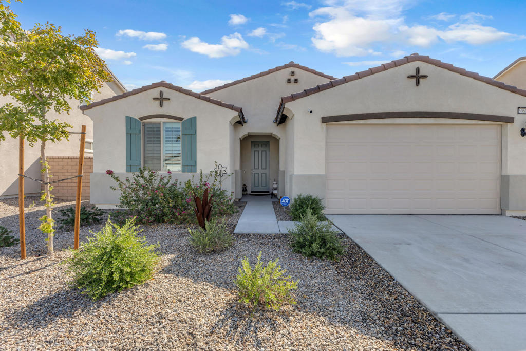 New construction home with paid off solar, lifetime warranty shutters throughout and cemented patio with mature fruit bearing trees. Extremely low utility bills thanks to tankless water heater, solar and efficient appliances. Here is a golden opportunity to own in the coveted Sevilla community of Coachella, just minutes away from festival attractions but far enough to still enjoy quiet and calm evenings under the stars on the private patio. Both adjacent homes are short term rentals and thus are empty most of the year lending to tranquil evenings with friends and family. Living and dining areas are open and inviting for social gatherings and keeping the family dynamic strong. Four bedrooms, two baths and a long hallway gives the home a spacious feel. Bathrooms have a total of two tubs and a walk in shower. This home is perfect for the single family or family with relatives allowing for everyone to have their own space. Full kitchen suite included with home. Don't miss this opportunity to own a well kept pride of ownership house you can call home.