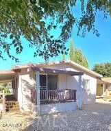 Move on into this 1984, Double wide, 3+2 Manufactured Home. Home was renovated about 18 months ago. Renovation includes: New Roof, New Flooring, Interior/Exterior Paint, Toilet & Faucets (both bathrooms), New cabinet in Guest Bath, 10 New support piers (sub area). Home equipped with central heat, new king cool window Evaporated Cooler in Living Room. New faucet and dishwasher in kitchen. Primary bedroom has Ensuite Bath and Walk-In closet, also, a sliding glass door leading out to a small deck in the backyard for early morning coffee. Front deck and back deck have new carpet. This home sits on a corner lot. Fenced on 3 sides with storage shed, covered parking for 2 cars. Low maintenance yard. Park is owned by the City of Palmdale. Space rent is approx. $650/per month. Water and trash added to rent statement. Park is gated with guards at the main gate. Park has an RV parking area. Club house has pool and spa, club room, playground, basketball court and tennis court.