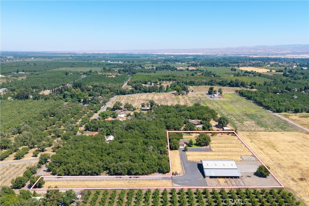 Well thought out equestrian estate on the western edge of Chico - opportunities for property like this don't come along often! There are five level acres with a covered arena, a six stall, 100' long, horse barn with a tack room, bathroom, heated wash rack and hay storage area! The property has been fenced into 8 irrigatable pastures, with 6 additional runs off the barn, a round pen, and then the 2,068 sq.ft. custom home at the corner of the property. Each pasture is fenced with no climb horse fence and has water and sprinklers available, not currently irrigated. Drive up the lane to the custom three bedroom, two bath home, was built in 1988 and has only had one owner. The living room has vaulted beam ceilings, a brick hearth and propane fireplace. There is a formal dining room, with a slider to a cool and shady covered patio that runs the length of the north side of the home. The kitchen has tile floors, Corian counters, oak cabinets and stainless fridge, with a bay window above the sink, overlooking the private side yard. A light and bright breakfast nook overlooks the front yard, pastures and towards the barn. The primary bedroom has a walk-in closet next to the primary bath, and it's own slider leading to the back patio. The yard is nicely landscaped, auto sprinklers and behind it there is a small orchard, grapes and plenty of room for a spacious garden. The property has a gated entrance, two wells and the barn has it's own septic, with RV hookups. Both septics have just been pumped. There is also a Generac generator for the house, in case of power outages. In just two minutes, you can be back in Chico and picking up groceries at Safeway. CA State University Chico and Enloe Hospital are both within a few minutes drive. A couple miles to the west of the property, the Sacramento River meanders south, offering a wide variety of fishing opportunities. If you're looking for a lovely equestrian property and home, not far from town, please schedule your private tour!
