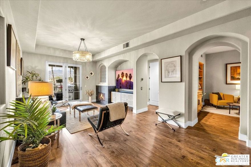 Sophisticated Desert Living with Breathtaking Mountain Views. Discover elevated living in this exquisitely upgraded Cortona Plan 2, nestled within the prestigious 55+ community of Villa Portofino in Palm Desert. Perfectly positioned to capture stunning mountain vistas and natural light, this sought-after floorplan seamlessly blends refined design with effortless comfort. From the moment you enter, high-end finishes make a statement - solid core doors, wide plank floating floors, elegant custom tilework, and bespoke window treatments set the tone for luxury throughout. Dramatic tray ceilings enhance the airy ambiance in the expansive living and dining areas, creating a grand yet welcoming atmosphere. The recently upgraded kitchen is a chef's delight, showcasing 42" upper cabinets, a Whirlpool stainless appliance suite, striking matte black hardware, quartz countertops, and a sleek tile backsplash with bar seating for casual dining. An inviting den, complete with an illuminated built-in wet bar and display curio, offers versatile space for an office, media lounge, or serene yoga retreat. The generously sized guest bedroom is ideally situated for privacy, with direct access to a beautifully appointed secondary bath featuring granite counters and a walk-in shower. The luxurious primary suite is a sanctuary unto itself, offering panoramic mountain views, an upscale ceiling fan, tray ceiling detail, and a spa-inspired ensuite with both a soaking tub and walk-in shower. A spacious walk-in closet with custom built-ins adds function to the elegance. Step outside to the covered patio easily accessed from both the primary suite and living area - where you'll enjoy expansive mountain views and plenty of space for outdoor dining or lounging in style. Convenience meets sophistication with both elevator and stair access, and the home is just moments from the expansive clubhouse. Enjoy world-class amenities including a private movie theater, full-service restaurant and bar, Olympic-sized pool, spa, a fitness center, yoga studio, 9-hole putting green, dog run, and an endless array of social and recreational activities. Located near premier shopping, dining, and entertainment, Villa Portofino offers not just a home, but a vibrant lifestyle. HOA dues include gated security, cable, internet, water, trash, insurance, roof maintenance, and all common area upkeep for true peace of mind.