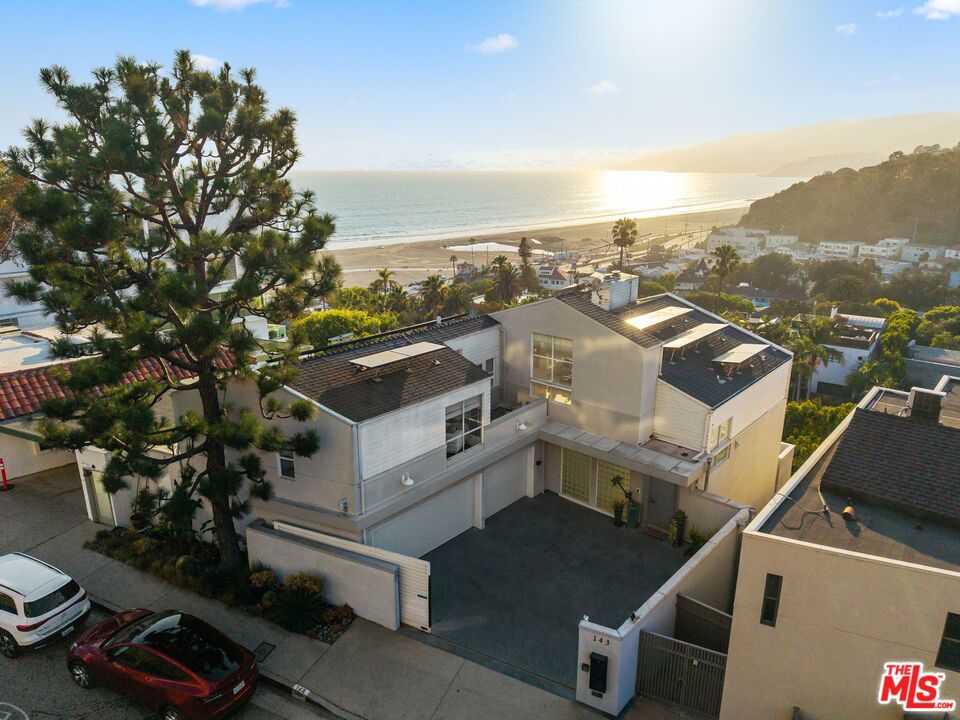 Spectacular Ocean and Canyon Views from nearly every room of this trophy home! Exceptional Ocean Avenue Extension location ideally situated near the beach and just block from Palisades Park! Over 6,200 sqft of living space with a flexible floorplan featuring a brand-new elevator, four bedrooms and lap swimming pool with spa. High ceilings and phenomenal art walls (if you need a break from the breathtaking beauty of the sparking Pacific Ocean and bejeweled Santa Monica Bay coastline). Beachy chic with light hardwood floors, large balconies, remote shades, solar panels, 3-zone HVAC, and loads of closet space! The large 6,120 sqft lot provides fantastic parking with a gated driveway and attached garage. Living room with fireplace, gorgeous dining room and large family room all enjoy the most incredible view! A separate guest wing with direct access could be an exceptional work-from-home option or ADU. Enjoy world-class sunsets from the generous primary suite which boasts a fireplace, sitting room, private deck, dual bathrooms and plenty of walk-in closet space. There is also a huge game/media room plus a "pantry room" and laundry & folding room. Bask in the afternoon sun and soak up wraparound views from the swim deck! Easy beach access via tunnel, just a block away! There is also an additional flexible-use space below the home (820 sqft which is not included in the square footage) that could easily convert to recording/art studio space or vehicle storage- a dream for any car enthusiast! This one-of-a-kind estate is an oasis, not to be missed!