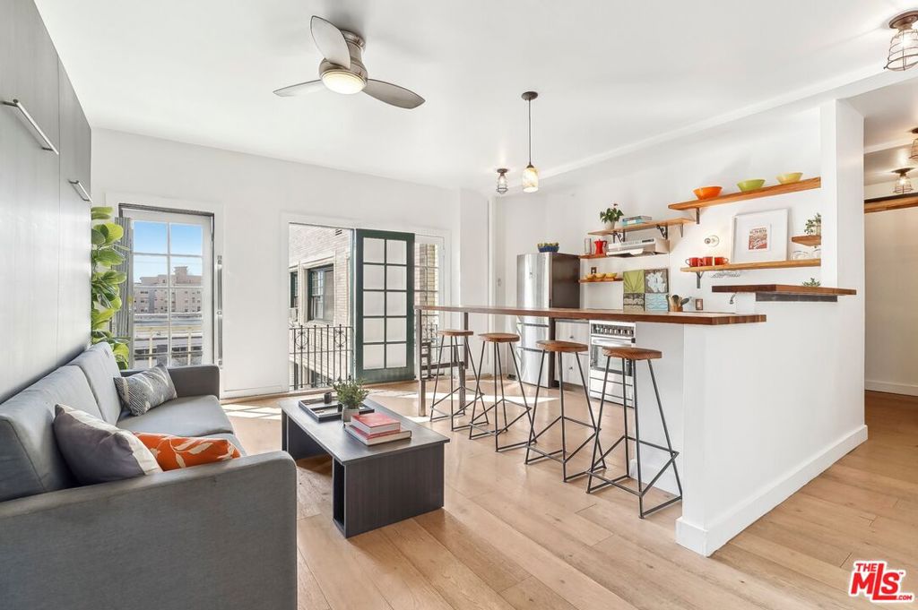 Here is your opportunity to own a part of Los Angeles history! This turnkey, top floor, courtyard facing, light and bright studio condo is ready and waiting for you. Situated in the stunning architectural Glen Donald building near downtown LA, all the city has to offer is just outside your doorstep. The control-access front gate opens up to a lush courtyard reminiscent of old Hollywood glamour. Once inside you will be welcomed into a charmingly classic lobby, with free wifi access for tenants. Next, head downstairs to the community room- complete with a ping pong and a pool table, and ample room for all to gather. There are also two laundry rooms, a fitness room, two changing rooms, and secure bike storage on this level. Getting up to the unit is a just quick elevator ride, or you can take one of many grand staircases to ascend to the fourth floor. Walking down the hall you will enjoy views of the mountains, the city and the iconic Hollywood Sign. The security of a Schlage keyless entry pad to your unit makes coming and going simple. Opening the front door you will be wowed by the sunlight flowing from the courtyard through three french door style windows. A handmade custom wooden top bar and stools create a perfect dining area facing the well equipped kitchen in this open floor plan. The stylish couch transforms into a Murphy bed which is perfectly suited to create a cozy sleeping area when entertaining is done. Additionally you will find an office nook, with a standing desk, and an artistic industrial style sliding door to create a separate spot to do your work. And there is still room to house a dresser and hang your clothes! The charm of the vintage bathroom tub and shower will offer a relaxing place to recharge at the end of your day. The HOA fees cover electric, gas, water, trash. While there is no parking offered on site, there are multiple paid private lots nearby. Close proximity to the Metro at the Westlake/MacArthur Metro station grants you access to all this area has to offer!