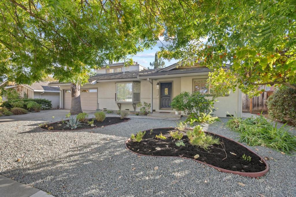 Welcome to this stunning 2,455 sq. ft. home with 4 bedrooms and 3 full baths, situated on a spacious 7,040 sq. ft. lot. This home offers two exceptional primary suites, ideal for versatile living. The expansive upstairs suite features an attached bath, a private seating area perfect for a home office, workout zone, or retreat, and abundant natural light. The downstairs primary suite offers a convenient, private haven for guests or in-laws. Enjoy upgraded features throughout, including Cal-Pack roofing, copper plumbing, fresh interior paint, hardwood floors, and new carpet and tile flooring. The bright, open floor plan boasts an upgraded kitchen, a large family room, a cozy tile-faced fireplace, multiple skylights, and ample storage. Dual-pane windows enhance energy efficiency. Outside, the beautifully landscaped backyard is currently a garden retreat with an oversized shed but could transform into an entertainers dream. Top-rated Cupertino schools complete this ideal family home.