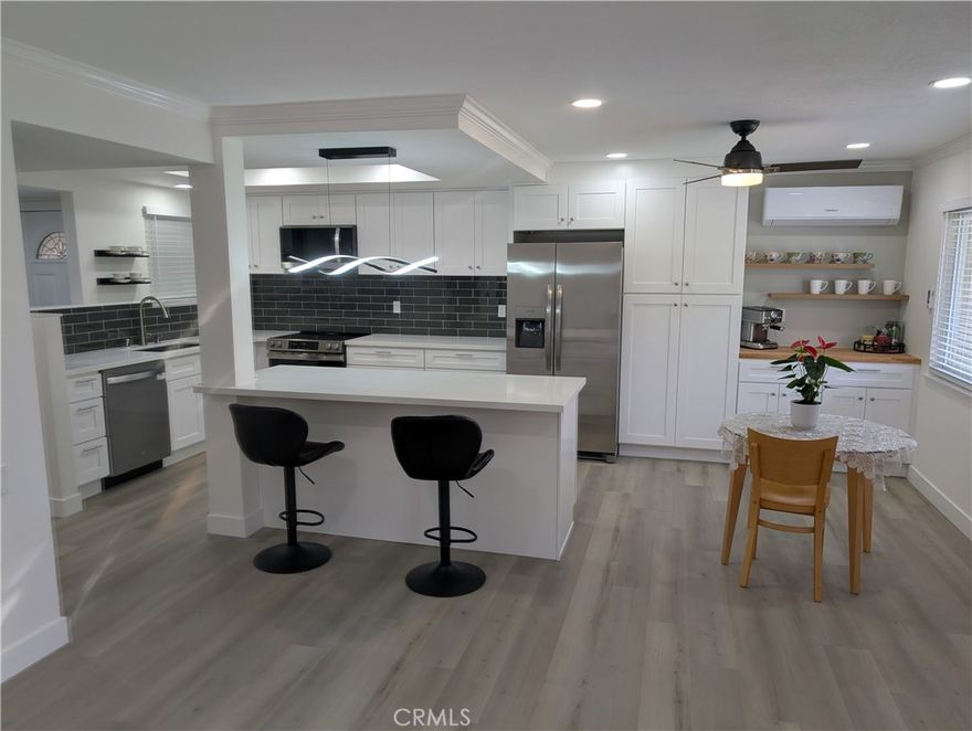 Welcome to your dream home in the heart of Laguna Woods! This extensively remodeled 2-bedroom, 2-bathroom condo is a masterpiece of modern design, offering unparalleled style, comfort, and functionality in a vibrant community.

Step into a bright and airy open-concept living space, accentuated by light-toned paint that creates a fresh and inviting atmosphere. The interior features stunning mahogany-style doors with glass accents, adding a touch of elegance and allowing natural light to flow seamlessly throughout the home. The gourmet kitchen is a showstopper, designed to be both aesthetically pleasing and functional. It boasts sleek white cabinetry, brand-new stainless steel appliances—including a full-size refrigerator and a sophisticated slide-in oven—and a chic, gray-toned floor that exudes contemporary flair. A large kitchen island offers extra counter space and seating for bar stools, making it perfect for casual dining or entertaining. A dedicated coffee area adds convenience to your morning routine, while abundant storage ensures everything has its place.

The adjacent dining area, complete with a ceiling fan for added comfort, flows effortlessly into the spacious living room. Here, an electric fireplace creates a cozy ambiance, making it the ideal spot for relaxing or hosting guests.

Both bedrooms are generously sized, each equipped with a ceiling fan for optimal comfort. The primary suite offers a private retreat, while the second bedroom is versatile enough for guests or a home office. Two beautifully remodeled bathrooms complement the home’s modern aesthetic with their thoughtful design.

Practicality meets luxury with a full-size stackable washer and dryer, a highly efficient central AC system to keep you cool year-round, and a nice-sized balcony perfect for enjoying morning coffee or sunsets with views of the Laguna Woods community.

This condo is more than just a home—it’s a lifestyle. With access to Laguna Woods’ world-class amenities, including golf courses, pools, and social clubs, this impeccably remodeled gem offers the perfect blend of elegance and convenience. Don’t miss your opportunity to own this stunning residence—schedule your private tour today!