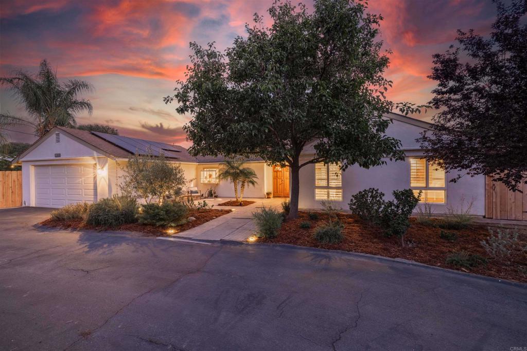 Welcome to 1454 Romance Road in Escondido—a home where thoughtful care shows in every detail. Set on 1.36 acres of mostly flat, usable land, this property offers endless possibilities. Whether you’re thinking of adding an ADU, creating a horse property, building a sports court, expanding gardens, or simply enjoying the wide-open space, the possibilities are endless. A separate gated driveway leads to the back of the lot, making access easy for future projects, RV parking, and additional structures. The south-facing living room is bright all day long, filling the home with natural light. The primary bedroom offers privacy and calm, complete with a walk-in closet. With three bedrooms, two baths, and an additional finished office space of about 350 square feet with power and its own wall A/C, the layout is practical and adaptable. Outside is where this home really stands out. A large pool and spa overlook beautiful hills, with a wraparound deck perfect for relaxing or entertaining. The owners also added a full outdoor kitchen—featuring a wood-fire pizza oven, grill, fridge, and sink—making this space functional for gatherings. Beyond the features, this home has been meticulously maintained and upgraded. It has 39 owned solar panels, a brand new A/C system, new spa heater, new pool pump, and refreshed pool deck. The entire exterior has been redone with new stucco, and inside, all toilets were replaced, fresh touch up paint, and a custom-built kitchen island was installed for more storage and counter area. The property’s landscaping has been fully redone with new irrigation, fruit trees, native plants, and low-water vegetation. A redwood and hog panel fence now encloses the main home, office, lawn, and vegetable garden. Electrical upgrades include a 240v EV and/or RV charger outlet, new outlets throughout, and updated lighting fixtures inside and out. Every improvement—from drainage updates to a new garage door opener—was made with long-term comfort and efficiency in mind. 1454 Romance Road offers luxury, peaceful living, and the rare kind of space that invites both relaxation and potential—with a dash of fun in the form of your very own garage skatepark.