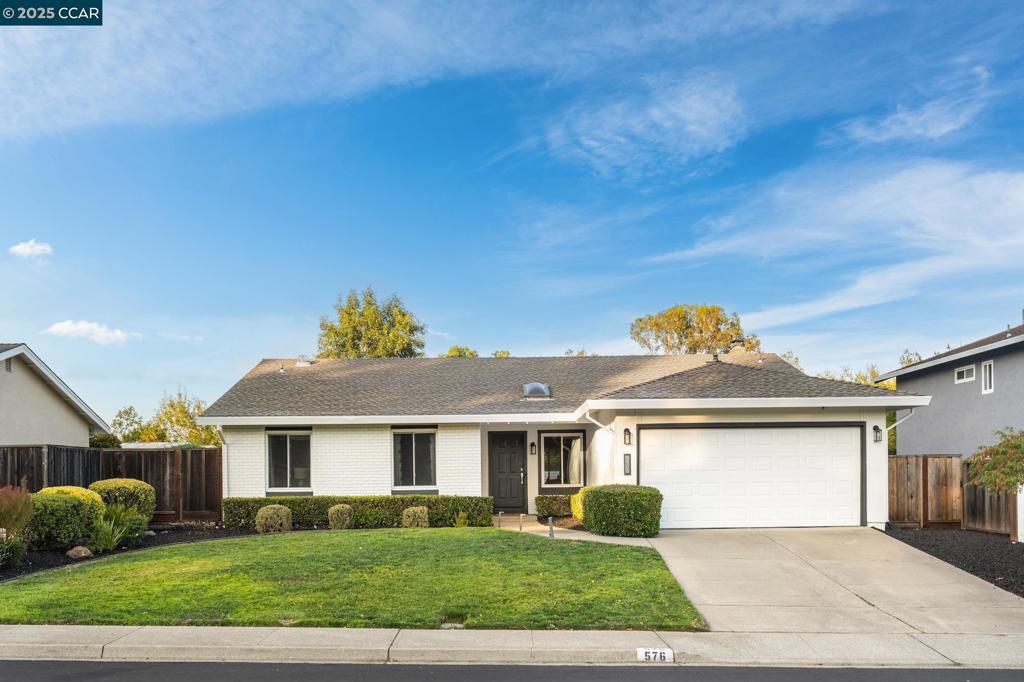 Welcome to this beautifully remodeled single-story home offering 3 bedrooms and 2 bathrooms of modern comfort. Step inside to an open, light-filled floorplan featuring vaulted ceilings, wide-plank hardwood floors, and designer lighting. The chef’s kitchen is a standout with sleek gray cabinetry, quartz countertops, subway tile backsplash, stainless steel appliances, and breakfast bar seating. The dining area, accented by a stylish fireplace, flows seamlessly into the living room and out to the backyard—ideal for entertaining. The primary suite provides a peaceful retreat with an en-suite bath, while two additional bedrooms and a home office provide flexibility. Outside, enjoy a private, low-maintenance backyard complete with an oversized patio with a newly constructed pergola, and synthetic lawn—perfect for gatherings or everyday relaxation. With fresh landscaping and timeless curb appeal, this move-in ready home combines style and convenience in every detail. Located within the award-winning San Ramon Valley School District, close to parks, shopping/dining at the popular Bishop Ranch City Center & freeway access.