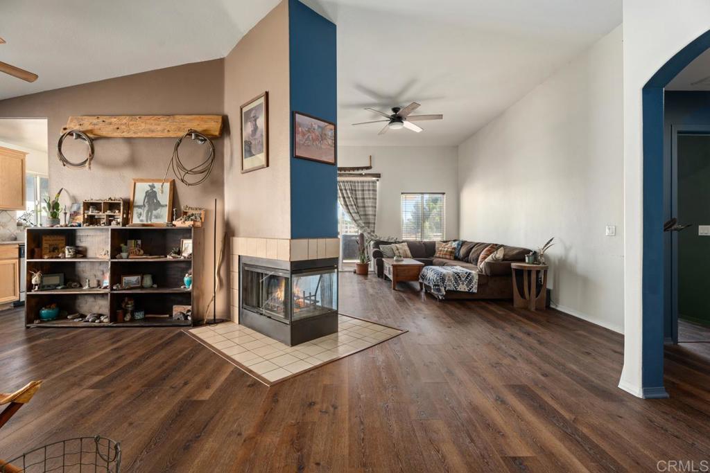 Perfect location at the end of the cul-de-sac with plenty of visitor and additional parking just across the road. Access to RV parking and walking trail just a few steps away. Popular 1628 sq. ft. 3BD, 2 BA model with many special upgrades. Luxury vinyl plank flooring throughout, granite countertops and decorative tile in kitchen, custom concrete in patio and many other unique touches. A big beautiful custom shed enhances your options for exta storage or a private little hide-away outside. Fireplace with gas light separates the living and dining room. This gated community boasts an expansive play area with sparkling pool, basketball courts, walking trail, picnic areas and lots of open space. Water and sewer are per the County and included in your property tax.