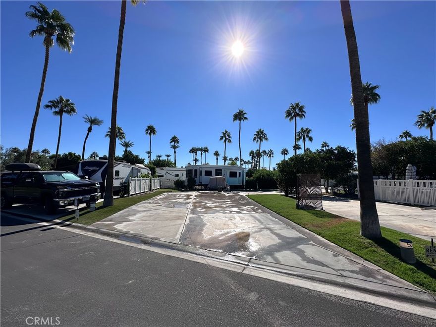 Well-maintained Lot 51 located in Phase 1 of the prestigious Outdoor Resorts Palm Springs RV Resorts Community. This property features clean concrete surfaces, vinyl fencing, a majestic palm tree, astroturf lawn with a small planter, and is surrounded by friendly neighbors. Ideally situated close to the La Palma Clubhouse, mailroom, pool, tennis courts, gym, and café, as well as Satellite A, which offers additional pool, spa, laundry, shower facilities, and tennis courts. Enjoy resort-style living in this vibrant, guard-gated community featuring 137 beautifully landscaped acres, featuring:27 holes of executive golf, 10 tennis courts and 13 pickleball courts, 8 sparkling swimming pools, fully equipped state of the art fitness center, cafe, on-site salon/barber shop, two clubhouses hosting year-round activities, events, and entertainment. Whether you’re seeking an active social scene or a peaceful retreat, Outdoor Resorts Palm Springs delivers the best of both worlds. This is more than just a lot—it’s a lifestyle!