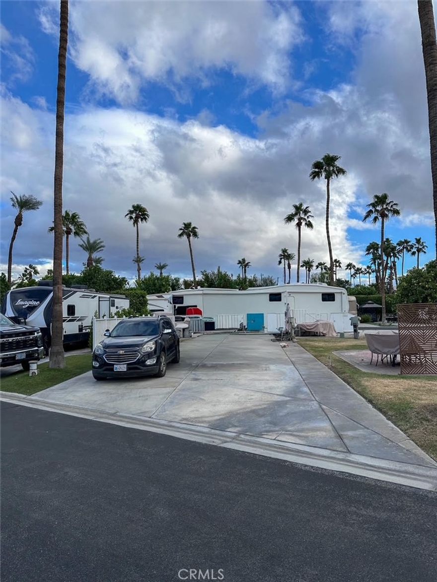 Well-maintained Lot 51 located in Phase 1 of the prestigious Outdoor Resorts Palm Springs RV Resorts Community. This property features clean concrete surfaces, vinyl fencing, a majestic palm tree, astroturf lawn with a small planter, and is surrounded by friendly neighbors. Ideally situated close to the La Palma Clubhouse, mailroom, pool, tennis courts, gym, and café, as well as Satellite A, which offers additional pool, spa, laundry, shower facilities, and tennis courts. Enjoy resort-style living in this vibrant, guard-gated community featuring 137 beautifully landscaped acres, featuring:27 holes of executive golf, 10 tennis courts and 13 pickleball courts, 8 sparkling swimming pools, fully equipped state of the art fitness center, cafe, on-site salon/barber shop, two clubhouses hosting year-round activities, events, and entertainment. Whether you’re seeking an active social scene or a peaceful retreat, Outdoor Resorts Palm Springs delivers the best of both worlds. This is more than just a lot—it’s a lifestyle!