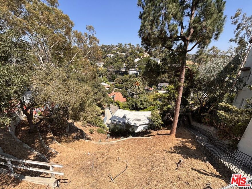 Beachwood Canyon view downslope lot on a quiet street in the Hollywood Hills. Property is next to the historic Beachwood Stairs. Buyer to verify information with City of Los Angeles Building & Safety and Hollywoodland Specific Plan. Survey available.