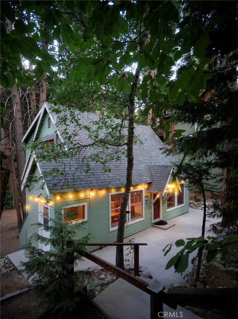 Walk to the Village from this classic Arrowhead charmer with lake rights! Discover the perfect balance of space and warmth in this stunning mountain retreat. From the moment you step inside, you’ll be greeted by the timeless charm of a beautiful knotty pine interior that radiates rustic elegance. The heart of the home—a renovated kitchen—features beautifully painted cabinets, gleaming granite countertops, stainless steel appliances, and modern flooring, creating a space that blends mountain character with contemporary convenience. The open layout flows effortlessly into inviting living areas, complemented by carpeting that enhances the home’s cozy feel. Upstairs, you’ll find a spacious master suite—your private sanctuary—while two additional bedrooms on the main level provide comfort and flexibility for family or guests.Step outside and soak in the serenity of a large, wooded lot with level areas perfect for outdoor entertaining or play, and a picturesque stream that meanders through the property, adding a soothing natural soundtrack to your days. This is more than a cabin—it’s your gateway to lake life at its finest.