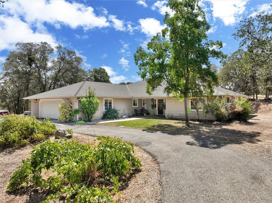 This is a must see! This custom-built home on 2.5 acres tucked into the Sierra Nevada foothills offers peace and quiet at the end of a cul-de-sac. As you step foot into this lovely home, you will notice how open yet cozy it is. The Brazilian acacia flooring and the German Beechwood kitchen cabinets, linen cabinets and den bookcase lends a polished and warm feel to the home. The kitchen features granite countertops, recessed lighting, tray ceiling and walk in pantry. The master suite is roomy and comfortable with French doors leading out to a gazebo covered patio and a large hot tub. The other 2 bedrooms are en suites with both having their own full bathroom. The bonus room features barn doors for privacy and can be used as an office, den, work out space or an extra bedroom. To add to all these amazing features, the home also boasts a covered back patio, a large shop, a pole barn and sheds to store your extra items. To top it off the home also offers owned solar and 2 year Roof Certification! This one won't last long! Make your appointment today!