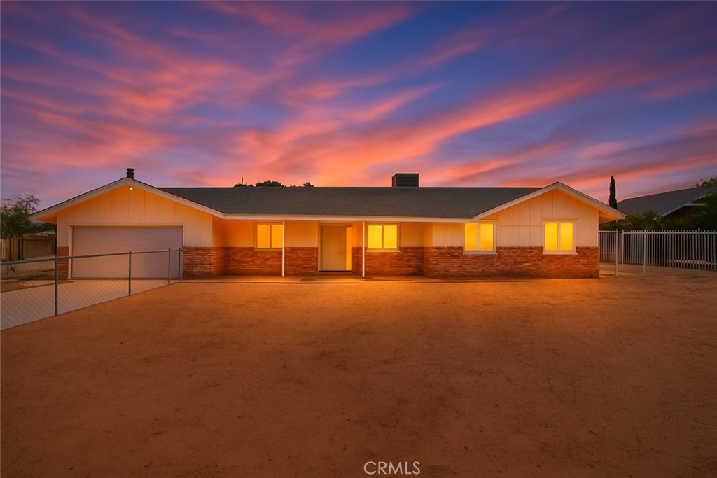 Welcome to 21248 Rancherias Rd in Apple Valley!
This charming ranch-style home perfectly blends original character with thoughtful modern updates. Offering 3 spacious bedrooms and 2.5 bathrooms, including a rare half bath in the finished garage, this home is move-in ready and packed with personality.
Step inside to find porcelain flooring throughout, a fresh neutral palette, and a bright, open floor plan. The formal living room flows into the dining area, complete with a custom built-in wine rack—perfect for entertaining. Just off the kitchen, the cozy family room showcases a beautiful brick fireplace and new sliding glass door leading to the backyard. The kitchen itself features plenty of countertop space, ample cabinetry, a pantry, and a handy eat-up bar.
The primary suite offers backyard access, a spacious layout, and a modern ensuite bathroom with a walk-in shower. Secondary bedrooms are generously sized—one with a split flooring design and the other featuring new windows and mountain views. The guest bath retains its retro charm with a unique drop-down bathtub and vintage blue tile.
Outdoors, this property truly shines! The backyard is fully fenced and cross-fenced, featuring low-maintenance concrete landscaping, a built-in firepit, RV access, and even a shade tree with a whimsical treehouse. The finished garage with its own half bath makes it easy to host gatherings or work comfortably on projects.
Additional highlights include a newer HVAC system, majority of windows have been retrofitted, and a quiet neighborhood that’s still conveniently close to shopping, schools, and the hospital.