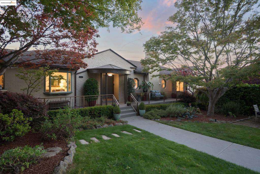 Perched above the city in coveted Oakmore and gated for privacy, this 5BD/4BA estate offers nearly 4,000 sq ft of light-filled living on over 1/3 acre of lush, park-like grounds. Walls of glass frame sweeping Bay views from the dining room, curved-glass breakfast nook, and living room opening to expansive decks for effortless indoor-outdoor living. The main level features a formal living room with fireplace, a well-appointed kitchen, and 4 bedrooms, including a gracious primary suite with panoramic views, spa-like bath and large closets. The lower level, with guest suite, home gym, a second kitchen and spacious family room with fireplace, is perfect for guests, entertaining, or multigenerational living. Outside, enjoy a level lawn, play structure, meandering paths, greenhouse, chicken coop, hammock hideaway, firepit patio, and a hot tub nestled among the trees. Additional highlights include a wine cellar, workshop, and ample storage. Located just a few blocks to Rocky’s market and Oakmore shops and restaurants, minutes to Montclair Village and commuter routes, 1971 Hoover Avenue is a rare blend of timeless design, versatile spaces, and East Bay elegance.