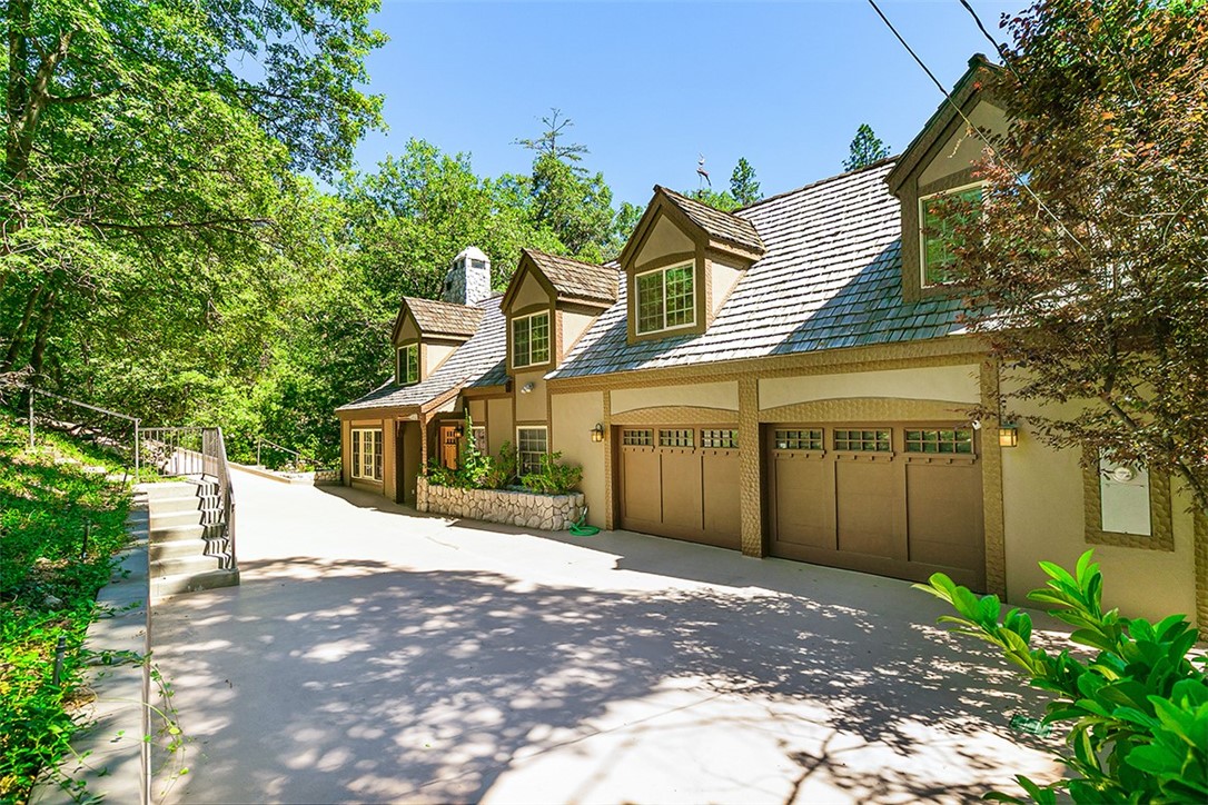 Your Dream Home Starts Here!!
Situated within highly acclaimed ‘North Shore’ Gated Community this picturesque Family Lodge is beautiful and well-constructed. A feeling of warmth and comfort pervades throughout, with customed beamed ceilings and immaculate wood floors. The well-appointed Kitchen combines with the Living Area and opens to an entertaining Deck which is surrounded within lush green trees and foliage. This private Deck is peaceful and quiet and the reason one moves to the mountains! There is an easy walking path that leads to the ½ Double Dock which is included in the sale! There are 3 Fireplaces! Air Conditioning! Oversized Double attached Garage and good off-street parking! There are 3 Bedrooms, a Library/Study which could easily be a 4th Bedroom, Sauna, and a Fantastic versatile Room which was designed as a Hobby/Wardrobe Room that could accommodate whatever a new owner may require! The Primary Bedroom suite encompasses the entire Lower Floor with Fireplace, Full Bath, Custom Large Closets and enjoys a private beautiful garden patio, lush with foliage. One of a Kind! You will Love this place!