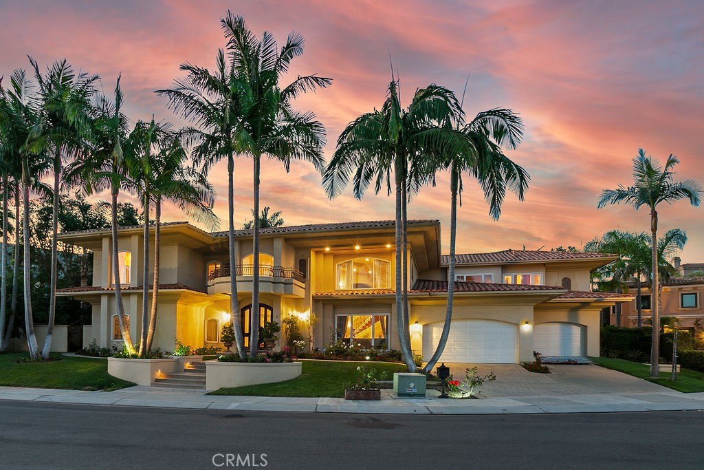 Located inside the 24-hour guarded gates of Ocean Ranch, one of Laguna Niguel’s most prestigious communities, this custom-built cul-de-sac residence offers nearly 7,000 square feet of coastal luxury on an oversized, nearly half-acre lot!! The floorplan is exceptional! The home opens with dramatic impact—a soaring 25-foot foyer and a sweeping wrought-iron staircase that sets the stage for what lies beyond. The main level flows effortlessly for both everyday living and large-scale entertaining. A spacious living and dining room connects to a bright family room and wet bar, all overlooking the resort-style backyard. Here, a recently remodeled pool with cascading waterfalls, a spa, and landscaping create a retreat designed for gatherings under the California sun. The chef’s kitchen, anchored by a large island and walk-in pantry, is perfectly positioned with views to the pool and tropical greenery. Just beyond, the main-level primary suite offers its own private entrance—ideal for multi-generational living or extended-stay guests. Upstairs, the second primary suite impresses with an oversized walk-in closet and a spa-like huge bath. Two additional bedrooms with en-suite baths, a large loft with balcony, (perfect for a theatre room) and a private office provide abundant space for both work and relaxation. Additional highlights include four full baths, two half baths, newer PEX piping, dual water softening systems, and a spacious three-car garage. The grounds also feature mature fruit trees, including avocado, adding a touch of California character. Ocean Ranch itself offers resort-style amenities—a pool, playground, and sport courts—all within close proximity to top-rated schools, shopping, and fine dining. Minutes away are the Waldorf Astoria, Ritz-Carlton, Monarch Beach Golf Links, Dana Point Harbor, and the iconic beaches of Southern California.