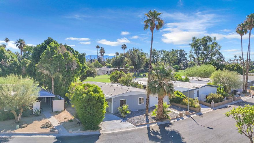 Welcome to Date Palm Country Club, where comfort, style, and convenience come together in this beautifully updated 1,775 sq ft manufactured home. Located in one of Cathedral City's most desirable 55+ communities, this spacious residence has been thoughtfully upgraded with new windows, a new energy-efficient AC system, fresh interior paint, and modern flooring throughout. Step inside to a bright, open floor plan filled with natural light and designer finishes that add warmth and elegance to every room. The stunning living room features a fireplace that serves as the focal point, creating a cozy yet stylish atmosphere. Large sliding glass doors lead to the covered patio, offering the perfect setting for indoor-outdoor entertaining and relaxing year-round. The kitchen and bathrooms have been completely remodeled with gorgeous modern design, featuring high-end finishes that elevate the look and feel of the home. The kitchen is equipped with brand-new energy-saving appliances and opens seamlessly into the dining and living areas--ideal for hosting friends and family. Both bedrooms are generously sized, offering comfort and privacy, and the refreshed bathrooms reflect modern taste and functionality. Additional features include an attached garage, private side yard, and covered outdoor space--perfect for enjoying the desert evenings. Located within a gated golf course community offering resort-style amenities such as pools, spa, tennis, clubhouse, and more, this home offers both luxury and lifestyle. Don't miss the opportunity to own a move-in-ready home in a prime location with all the upgrades already done for you!