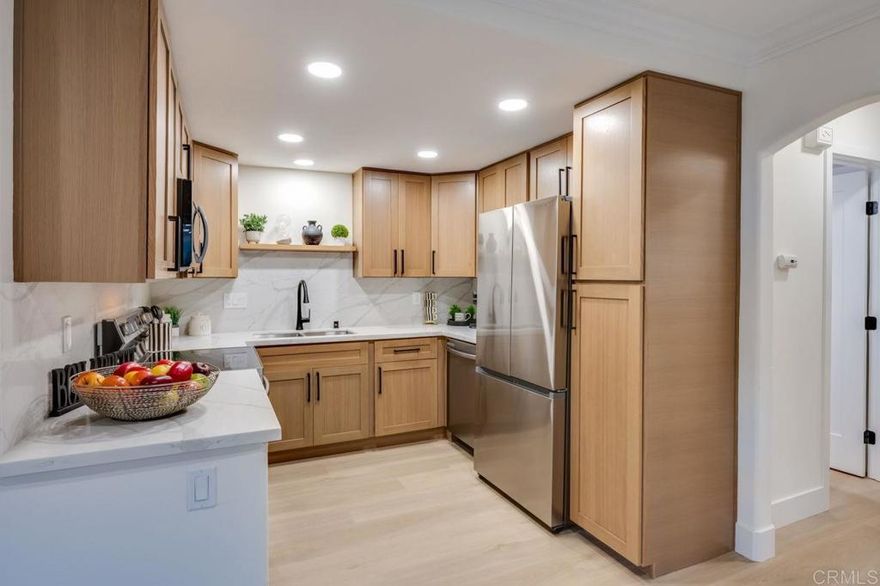 Welcome to this beautifully remodeled lower-level 1-bedroom, 1-bath condo offering 760 sq. ft. of comfortable living space and a private patio with in-unit laundry. This turnkey home showcases a custom renovation featuring plank vinyl flooring, recessed lighting, crown molding, new doors and hardware, and dual-pane windows throughout. The adjacent dining area flows seamlessly into a stunning Shaker-style kitchen appointed with quartz countertops, a designer backsplash, new stainless-steel appliances, and a counter-depth refrigerator with ice maker—perfect for both everyday living and entertaining. The spacious bedroom easily accommodates a king-sized bed and includes custom-designed closets by San Diego Closet Design along with a ceiling fan with LED lighting. The remodeled bathroom and new A/C and heating system complete this thoughtfully upgraded home. Williamsburg Square residents enjoy lush, well-maintained grounds, a swimming pool, a gym, men’s and women’s saunas with showers, and a reservable clubhouse with kitchen—ideal for gatherings. Visitor parking is conveniently located behind the complex. The low HOA fee covers hot water, trash, and sewer. Ideally situated in a highly walkable central location near La Mesa Village, Cowles Mountain, Lake Murray, Grossmont Center & Hospital, Costco, SDSU, and public transportation—this home offers the perfect blend of comfort, convenience, and style.