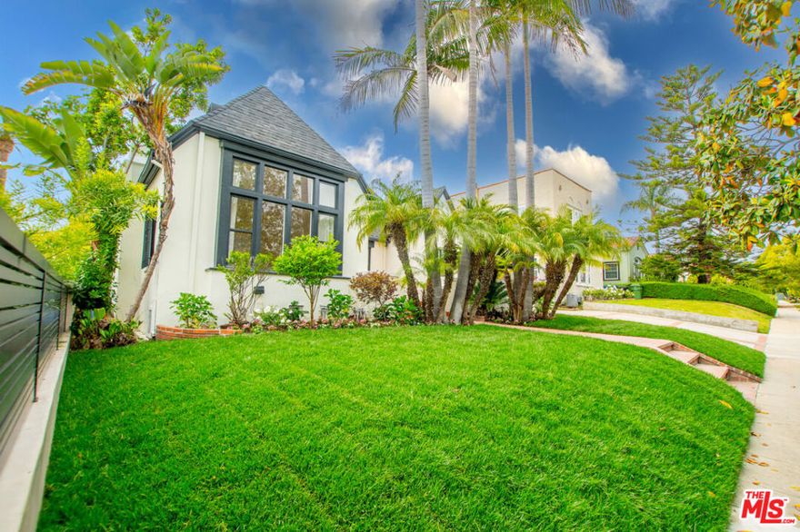 Enhanced Storybook Tudor w front porch, exquisite hardwood floors, new kitchen & bathrooms, 2 car garage, & outdoor living. Open the front door to the expansive living room boasting a barrel ceiling, large frontal windows, tons of natural light, & a fireplace. The formal dining room showcases another impressive window overlooking the front porch & is complemented by a coved ceiling. Through the dining room, enter the brand-new eat-in kitchen w a cathedral ceiling complete w brand-new SS appliances, countertops + cabinets, & a side exit to the driveway. The 3 BDs downstairs are spacious & the 2 bathrooms are newly renovated with a modern touch. The master BD offers an en-suite BA w dual vanity, a beautiful shower, & walk-in closet. BD #2 has sliding glass doors that offer access to the backyard/patio. All lower BD have walk-in closets & the laundry closet is tucked away in the hall w side-by-side WD. The loft upstairs provides extra privacy w another sizable bedroom. Entertain or enjoy family time in the backyard of the property - paved area w a basketball court + 2 car garage, grass yard w patio & pergola. View this property ASAP if you have your eye on the Hancock Park area. Swingset no longer on property.