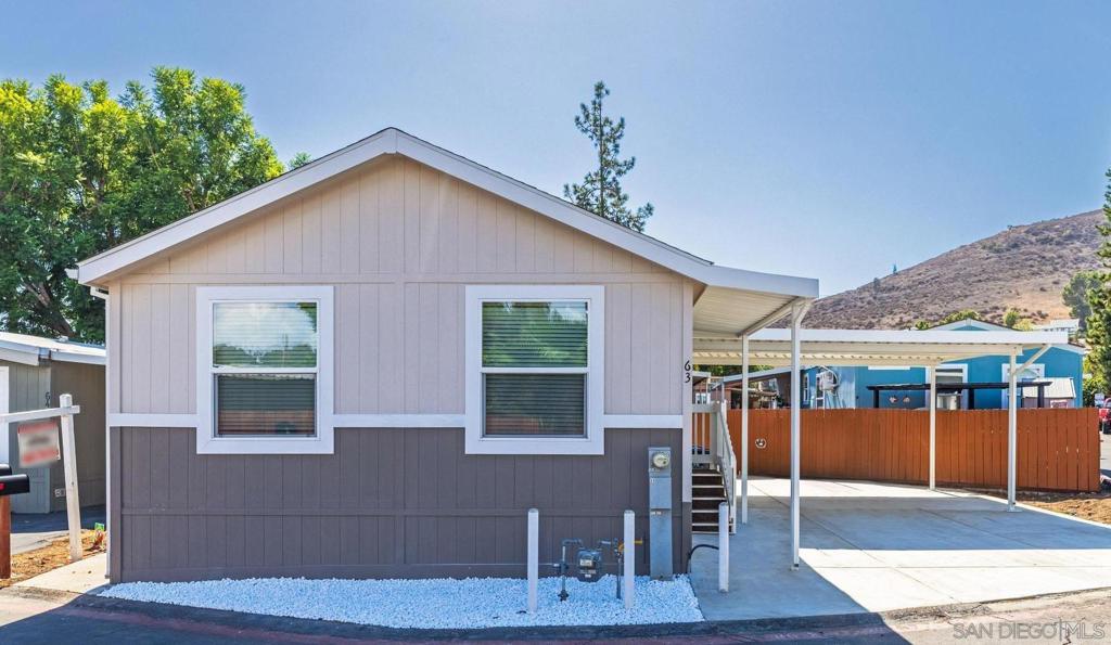 Priced to sell, this brand new 3-bedroom, 2-bathroom manufactured home can be yours! With the split floor plan, it is ideal for families with kids or roommates that want privacy. Upgraded stainless appliances in kitchen, includes: built in microwave, dishwasher, sink, side-by-side refrigerator w/water & ice dispenser. The kitchen offers modern white shaker cabinetry w/black hardware and pull-down faucet. Cook with ease in this convenient easy to maneuver through kitchen with an island and open concept to the living room. For the privacy you dream of, the primary bedroom is located on one side of the house with it's own bathroom, that offers a walk-in shower. While bedrooms 2 & 3 are on the opposite side of the home that offers a guest bathroom with shower/tub combo. Both bathrooms offer elongated toilets. No tandem parking, this carport offers convenient side-by-side parking. Nestled in the family friendly Westward Ho Manor, an all-ages community, Splash around and have fun in the sparkling swimming pool on sunny days. The park generously offers a spacious clubhouse, available for you and your family. Centrally located in El Cajon (on the border of Lakeside and minutes from Santee- shopping centers, schools, parks, dining, and freeways are right at your fingertips. All of San Diego County, including beaches and mountains are minutes away either east or west of your new home. Perfect if you're starting a family, wanting your first home, or ready to retire, this is the place you've been looking for!