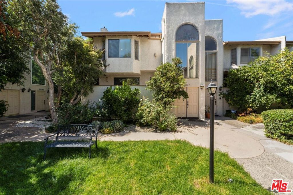This exceptional end-unit residence offers nearly 1,800 square feet of beautifully designed living space, and is perfectly positioned to capture the most desirable view in the entire complex. Just a short stroll from the sparkling community pool, relaxing jacuzzi, and inviting clubhouse, the home offers a seamless blend of comfort, style, and convenience.As you approach the property, you're greeted by a stately double-door entry adorned with charming stained glass details that glow warmly in the evening light, creating a welcoming and elegant first impression.Inside, the main level features a generous open-concept living and dining area, highlighted by rich wood flooring, recessed lighting, a cozy gas fireplace, and a built-in bar is ideal for entertaining guests or relaxing in style.The bright, well-appointed kitchen offers ample cabinetry and counter space, complete with matching appliances and a sunlit atmosphere that makes everyday cooking a pleasure. Just down the hall, a comfortable guest bedroom and full bath provide excellent accommodations for visitors or a flexible home office setup.Freshly painted throughout with brand new carpeting, the entire home exudes a sense of renewal and readiness for its next chapter.Upstairs, the secondary bedroom enjoys the privacy of an en-suite bathroom, while the expansive primary suite is a true retreat boasting soaring vaulted ceilings, sweeping views of the lush common areas, an oversized walk-in closet, and a spa-inspired bathroom with a large soaking tub, dual-sink vanity, and tasteful modern updates.The lower level includes a spacious two-car attached garage, a full-size laundry room, and abundant storage options adding to the home's overall functionality and convenience.