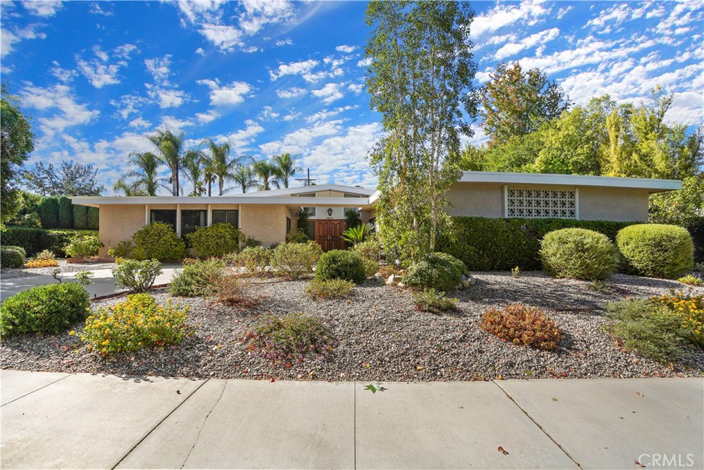 Exceptional single-story pool home located in prime Woodland Hills. A double wood door entry welcomes you into this spacious residence featuring high ceilings and wood flooring throughout. The formal living room with fireplace, formal dining room, and open family room all flow seamlessly to the backyard through three sets of French doors, creating the perfect indoor-outdoor living experience. The kitchen offers a garden window, breakfast area, and ample cabinet space. The primary suite includes French doors leading to the backyard, dual sinks, a soaking tub, and a separate shower. Large secondary bedrooms provide plenty of space and comfort. Lush landscaping in the backyard enhances privacy and complements the inviting covered patio and pool area. Additional highlights include a charming brick-inlay driveway, a thoughtfully designed floor plan ideal for entertaining, a newer roof and HVAC system, a beautifully resurfaced pool with updated tile work, and newly installed redwood fencing and side gate on the north side.
