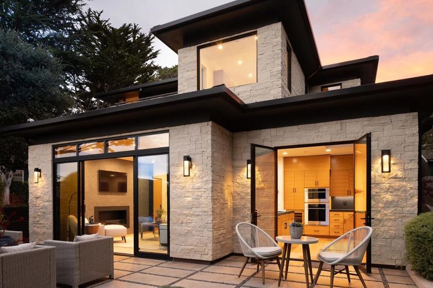 Designed by acclaimed architect Eric Miller, this luxury 3-bedroom, 3.5-bath residence offers approx. 2,004 sq ft of finely curated living on a rare 5,000 sq ft corner lot in Carmel's Golden Rectangle, just two blocks to the beach and one block to Ocean Avenue. Completed in 2020, the home embodies sophisticated coastal living with clean contemporary lines and perfect proportions. Expansive windows and walls of glass flood the interiors with natural light, highlighting rich hardwood floors, stone accents, and bespoke finishes. The airy open-concept design features a chef's kitchen, elegant dining, and a stylish living room anchored by one of two fireplaces. Upstairs, the serene primary suite enjoys filtered ocean views and glimpses of Pebble Beach, while two guest suites offer privacy and comfort. Radiant heat, metal roof, mini-split A/C, and detached garage provide modern convenience. Outdoor terraces extend the living experience, creating ideal spaces for entertaining or quiet retreat. With room to add an ADU and set in Carmel's most sought-after location, this home is a rare opportunity to own a modern coastal sanctuary of exceptional quality and timeless design.