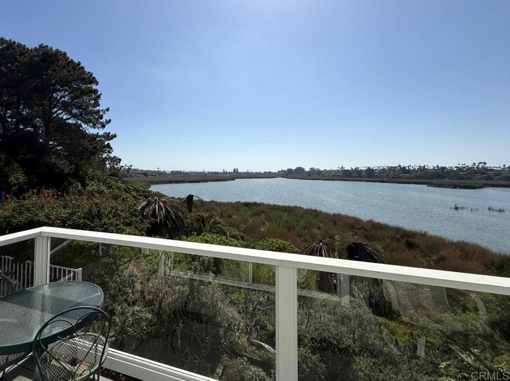 Wake up to shimmering lagoon views each morning and toast unforgettable sunsets every evening. This home features two primary bedrooms and two and a half baths, perfectly positioned on the edge of the Buena Vista Lagoon capturing panoramic lagoon and ocean views rarely found elsewhere. Water views grace the dining room, kitchen, and spacious back deck, seamlessly bringing the beauty of the lagoon into everyday living. Upstairs, the larger primary suite—with an adjoining retreat—faces the water, so every day begins with the sights and sounds of paradise. Just a short walk or bike ride away is the Carlsbad Village, where you’ll discover great shopping, amazing cafés, two Michelin-starred restaurants, and the vibrant farmers market on Wednesdays. Carlsbad State Beach is only blocks from the Village, keeping the sand, surf, and spectacular sunsets always within easy reach. Whether you’re searching for a full-time residence, a dreamy second home, or a turn-key coastal investment, this rare gem has it all: breathtaking views, an unbeatable location, and the quintessential Carlsbad lifestyle. Tucked west of I-5, this peaceful retreat feels like a vacation every day, yet still offers convenient access for commuting. Don’t miss your chance—schedule your private showing today and start living the Carlsbad lifestyle.