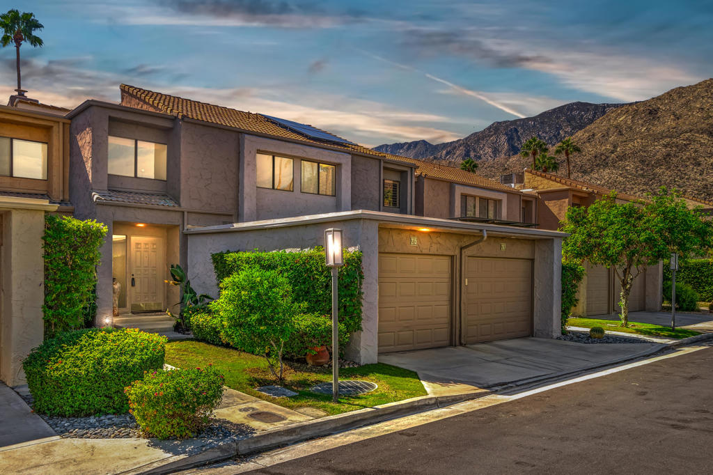 Discover the epitome of modern desert living in this revitalized 2-bedroom, 3-bath townhome, now being offered fully furnished. Embrace the elegance of a classic 1979 Hugh M. Kaptur design while enjoying contemporary upgrades that blend luxury with comfort. The inviting step-down living room, adorned with a cozy gas fireplace, opens through sliding glass doors to a generous patio. Here, you'll bask in the serene views of mature citrus trees, all while gazing at the sparkling community pool and spa. The kitchen is a chef's wonder, featuring sleek stainless steel appliances and ample counter and storage space, perfect for any culinary endeavor. Each bathroom has been thoroughly modernized, including the conveniently located powder bath on the main floor. Upstairs, you'll find two sunlit ensuite bedrooms. The primary suite offers a personal retreat with a gas fireplace, a wet bar, three closets (one cedar-lined), and breathtaking mountain views from it's spacious balcony. Newer tile flooring and freshly painted walls stretch throughout, adding an exciting stylish touch to the home. Nestled in the sought-after Canyon West Estates of South Palm Springs, this townhome is only minutes away from downtown Palm Springs' vibrant dining and shopping scene, with easy access to nearby hiking and biking trails. Experience the perfect blend of relaxation and excitement in a pet-friendly, vibrant, and secure gated community. Your ideal desert lifestyle awaits!
