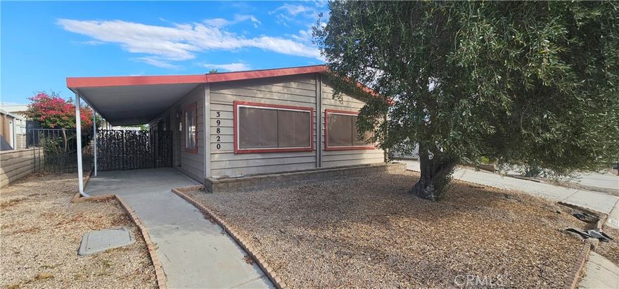 Great 55+ home located in the community of the Palm Desert Greens is located in the heart of Palm Desert. This cozy 1440 square foot single story manufactured home on a permanent foundation features 2 bedrooms, 2 bathrooms, has a large carport attached to the left, with a shed at the end of the driveway and a gated patio on the right. The entry, sitting room and living room feature carpet floors that flow throughout the house. Open floor plan with big windows surrounds the living & dining rooms. The kitchen features laminate flooring, a 4 burner stove and oven, microwave, dishwasher, plenty of cabinets for storage space and large counter space with a breakfast counter seating for three or more. A window beyond the sink fills the kitchen with natural light. The spacious laundry room features cabinetry and countertop space for storage, a built-in desk or folding table, laminate flooring, a jack and jill door to the bathroom, and direct access to the side yard. The master suite features laminate flooring, a ceiling fan, and a closet with mirrored sliding doors. A large window fills the room with natural light, while the private attached bathroom offers a separate walk in shower, a relaxing soaking tub and single vanity sink. The secondary bedroom also features a private full bathroom with a shower/tub combo, single vanity sink with a cabinet and a closet with mirrored sliding doors. Outside to an expansive gated patio on the left, ideal for entertaining and customizing to your taste. A spacious carport on the right, with a handy shed at the end of the driveway for extra storage. As a resident, enjoy access to the golf course and nearby clubhouse, offering amenities like a recreation center, tennis courts, and pool/spa facilities. Located near highways, shopping centers, and dining options. This home enjoys a prime location near major highways, offering convenient access to shopping, dining, and entertainment.