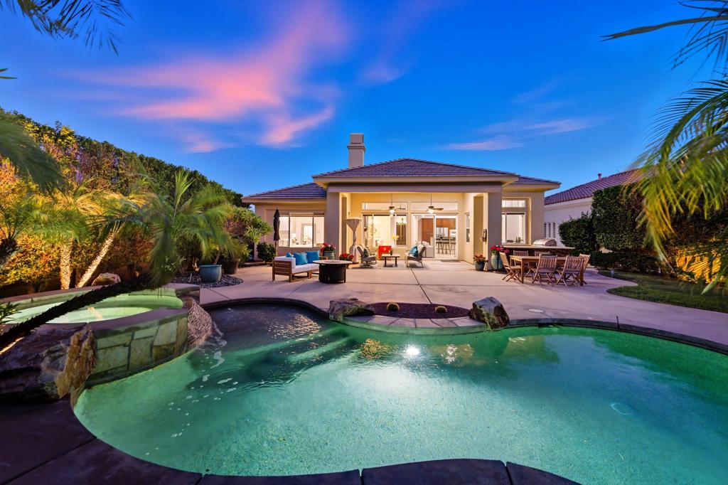 Discover your dream home in La Quinta's premier Mountain View Country Club, one of the friendliest and most active communities in the Coachella Valley. This sought-after Sedona floor plan excels in open-concept design, ideal for effortless entertaining. This spacious private lot off the golf course has beautifully landscaped backyard featuring an inviting covered patio equipped with awning and misters, a sparkling pool with raised spa, and a convenient built-in BBQ-- perfect for pets and family members of all ages. The gourmet kitchen showcases newly refinished cabinets, stainless steel appliances, a versatile island breakfast bar, and adjacent dining area. Flowing seamlessly into the great room, complete with a wet bar, cozy fireplace, and elegant built-in cabinetry, the main living spaces also include a formal dining room, versatile den/office, laundry room, and powder room. Superior bedroom separation ensures privacy, highlighted by the primary suite with direct backyard access, expansive walk-in closet, and spa-like bath offering dual vanities, a dressing table, and separate soaking tub and shower. On the opposite side, two additional bedroom suites each feature ensuite baths with luxurious walk-in showers. Mountain View Country Club residency requires a social membership ($10,000 initiation fee; $845 monthly dues), providing exclusive access to clubhouse dining, fitness center and classes, spa services, heated community pool, tennis, pickleball, bocce courts, and a dynamic social events calendar. The $545 monthly HOA encompasses 24/7 guard-gated security, common area maintenance, front yard landscaping, and a comprehensive Spectrum package. Optional golf membership available with separate initiation and dues. Staged furniture is available for sale.