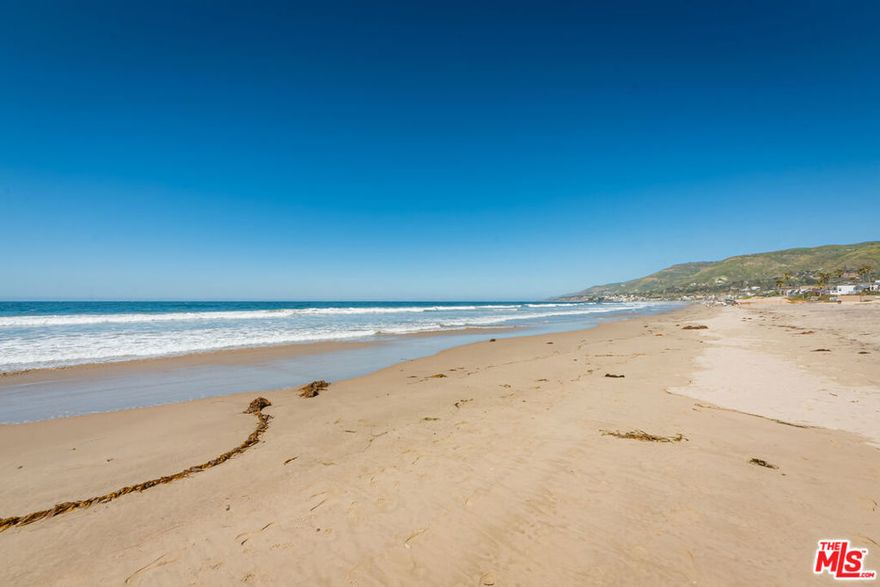 This gorgeous Point Dume gated compound with Little Dume/Riviera III beach key plus a private, gated path that leads to the beach, sits on more than 1.5 acres. Newly renovated, elegant, and ultra-private, this beautiful home is ideal for indoor-outdoor living and entertaining. At the heart of the house is an enormous great room with wood floors, high, wood-beamed ceilings, and a beautiful piano. This handsome room includes a living area, with gas/wood fireplace and built-in bookshelves, a dining area, and a gracious country kitchen with high-end appliances, large island, wood-burning pizza oven, dry-bar with ice machine, and butler's pantry with an additional pantry room. A wall of French doors open onto a huge flagstone patio. Off the great room, a family room doubles as a projection room, with blackout curtains over doors opening to the pool/spa terrace. A hallway with a window seat leads to the bedroom wing, where four bedrooms include two that share a bath, another en-suite, and the lovely owner's hideaway, which has a sitting area with a fireplace, a window seat looking out to the pool, double large closets, generous bookshelves, an office area, and a luxurious bathroom with freestanding tub, double-headed shower, double vanity, huge walk-in closet, and a wall of ocean-view windows. French doors open to a patio and lawn. Upstairs is an additional sleeping area with sitting area, fireplace, bathroom, and private deck with ocean views. The impressive grounds invite relaxation and grand hospitality. Features include a waterfall grotto pool/spa with a slide, sauna, outdoor kitchen and barbecue, large covered dining/sitting area with outdoor heaters and fireplace, flagstone patio with a fountain, sitting area with a fire pit, and extensive lawns. The yard is beautifully landscaped with fruit and other trees, and paths lead through the terraced plantings, including a vegetable garden. The outside space can also provide the opportunity to lodge chickens. There are two guest accommodations. The guest house is complete with sitting area with kitchenette, bedroom with fireplace, bathroom, walk-in closet, and a door to the patio and pool. A separate guest suite above the garage includes a great room with kitchenette, bedroom, bathroom, and French doors to a huge dining/sitting deck with ocean views. The property has garage parking for six cars and ample guest parking. Right along this exclusive beach path sits the surfboard shack, strategically positioned for maximum convenience. This is an exceptional home of rare size and quality created for the quintessential Southern California lifestyle. Yearly beach key fee.